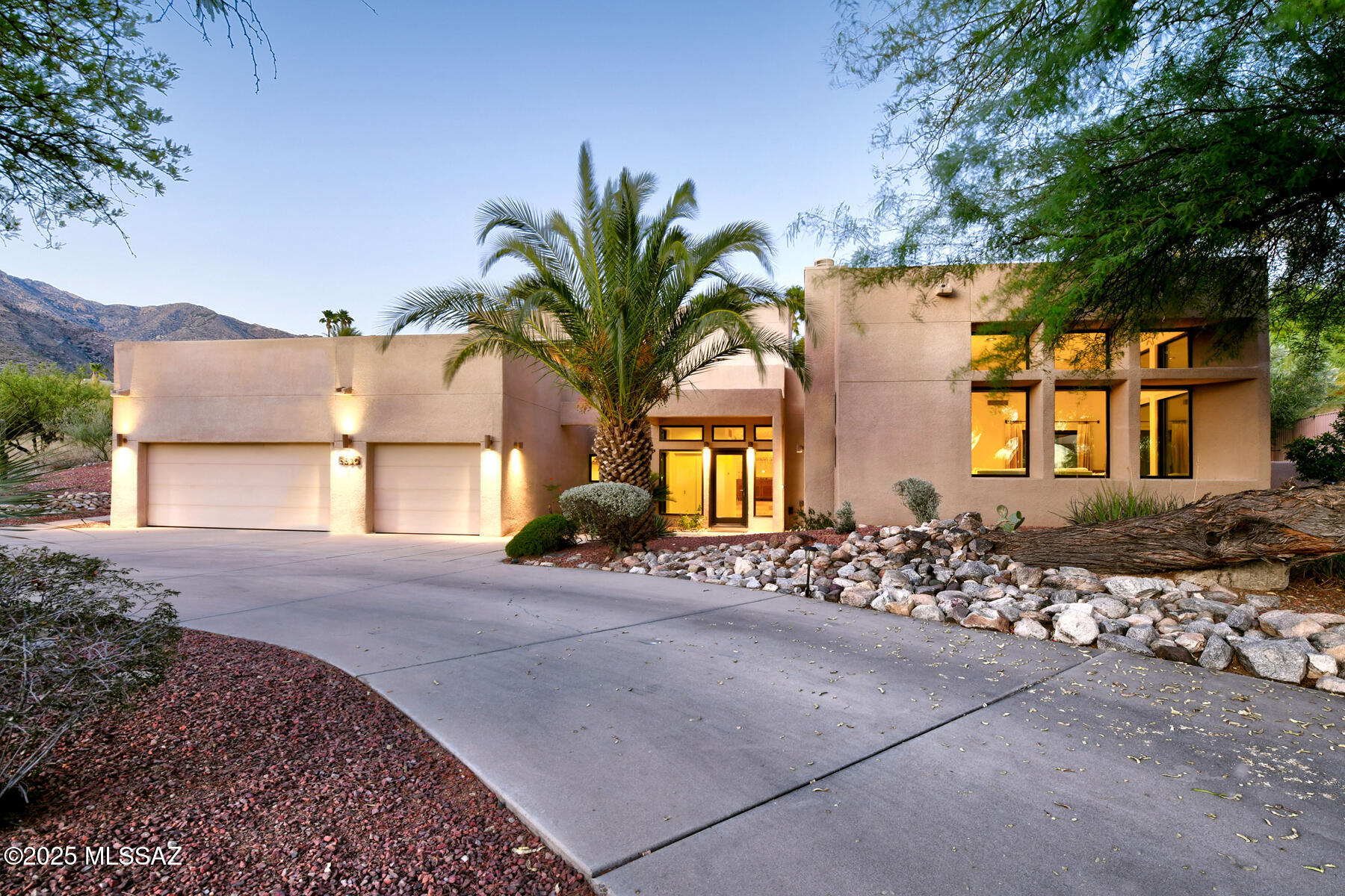 Welcome to this beautifully remodeled and updated soft contemporary home, ideally situated in the highly sought-after Regal Manor Estates in Tucson's Catalina Foothills. 
A circular driveway invites you in to explore this light-filled 4-bedroom, 2.5-bath residence spanning 3,389 sq. ft., where soaring ceilings, travertine flooring, and walls of windows create a bright and airy ambiance.
The living room features a fireplace and wet bar, perfect for entertaining, while the family room showcases a striking stacked-stone fireplace and direct access to the pool area. The stunning remodeled kitchen boasts quartz countertops, designer stainless steel appliances, a gas range and oven, sure to delight any home chef.
The elegant primary suite offers a serene retreat with a large picture window, wood-look ceramic tile flooring, and a beautifully updated spa-style bath complete with dual vanities, a Japanese soaking tub, a generous walk-in closet with built-ins, and private access to a rooftop deck above the garage. This unique outdoor space, finished with artificial turf, offers panoramic views of the Catalina Mountains.
Outdoor living is equally impressive, featuring two covered patios, one in the pool area and another expansive north-facing porch perfect for breakfast or relaxing in the shade. The backyard also includes a lush artificial turf lawn, stone walls, a fire pit, and captivating mountain vistas.
Additional highlights include lush, mature landscaping, a 3-car garage, owned solar panels, all in Catalina Foothills School District #16. Enjoy the convenience of being just minutes from golf, shopping, and restaurants. 
Truly a home that must be seen to be appreciated.