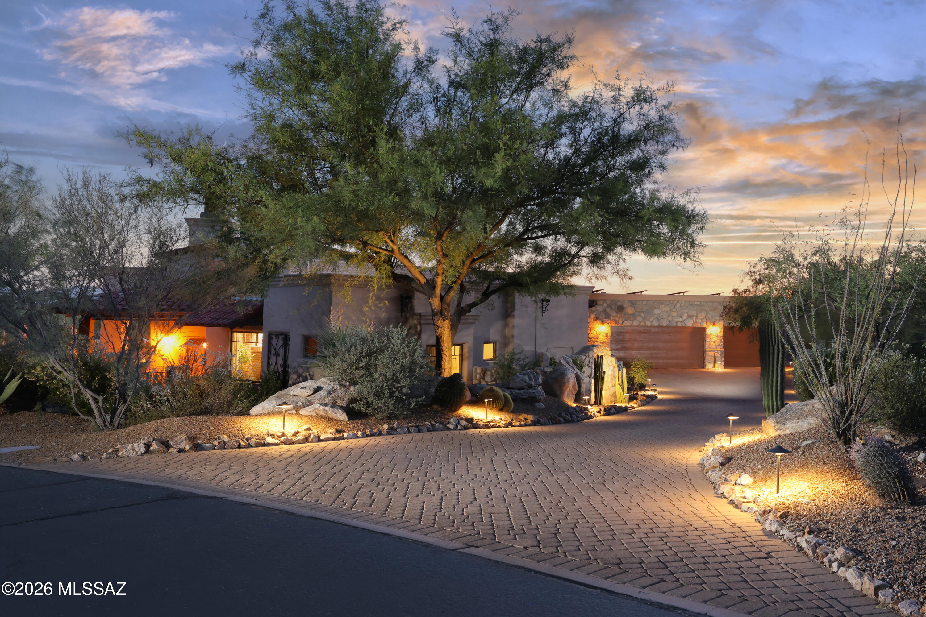 Timeless Tuscan country design creates charming retreat on private cul-de-sac with Catalina views in Stone Canyon, an exclusive guard-gated golf community in Oro Valley. Bordered by stone walls, this beautifully furnished ~3,700 SF custom design (great room, 4 suites, 5BA) melds rustic design with luxury amenities. Arched 9' entry door, Cantera columns, massive Cantera Fpl, inset soffit ceiling with wood beams, Wine Room, Chef's Kitchen (Viking stove, pot filler, 2 D/W, Warming Drwr, M/W, 48'' Ref/Fz, island w/prep sink). French doors lead to brick paver patio, Pool, Spa, Gazebo w/Fpl, Bocce Ball crt, Rooftop deck overlooking acres of open space. Romantic main suite with brick Fpl, spa-like bath (towel warmer, heated floor, TV) & outdoor Sauna. Owned Solar & Oversized 3-Car Garage. OH 6/7!