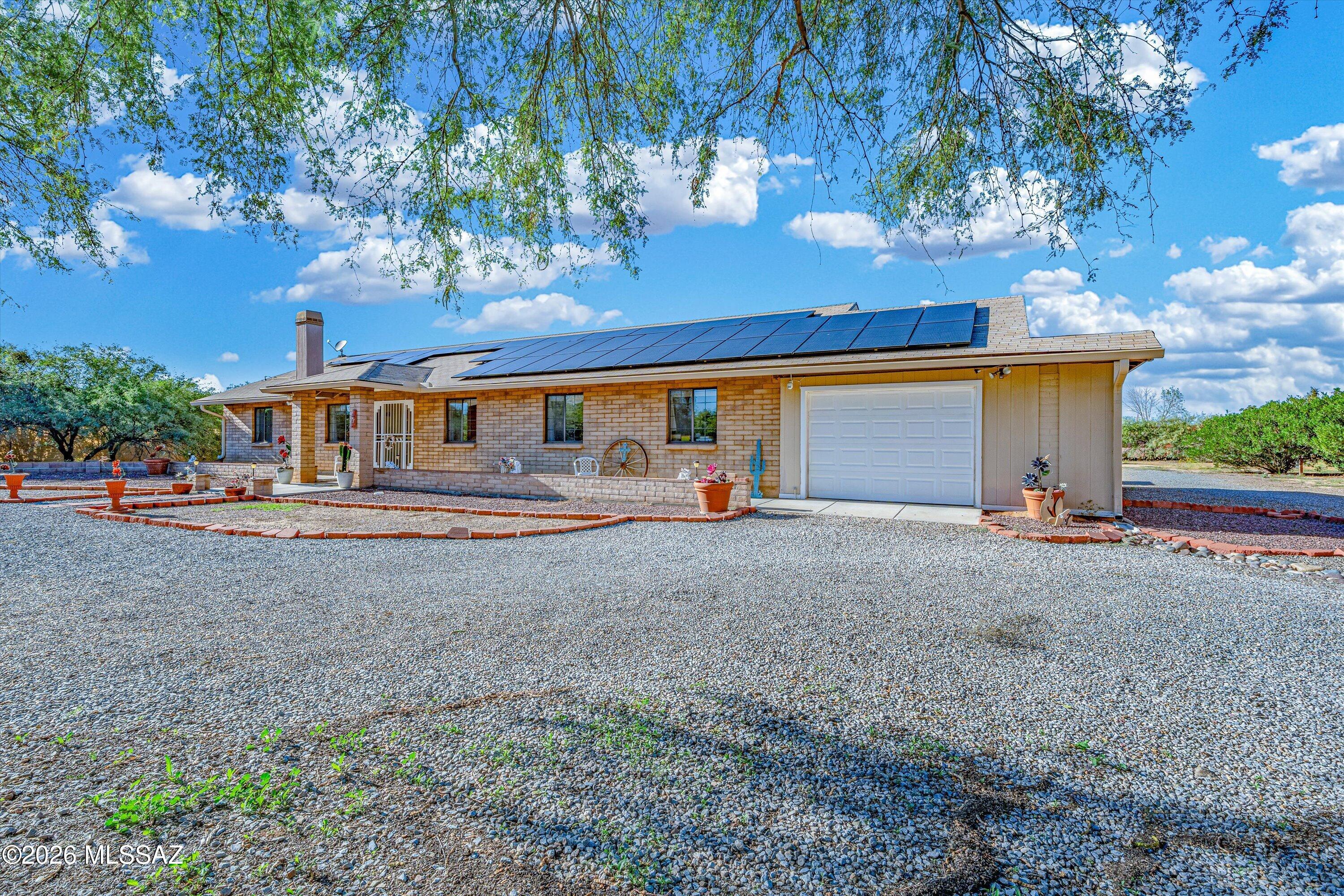 Room to live, work, play and spread out on just over an acre! This 4-bedroom, 3.5-bath home offers versatile living space with a split-bedroom floor plan designed for both comfort and flexibility. A spacious family room anchored by a fireplace creates a welcoming gathering space, while the home's layout provides options for guests, a home office or additional private living space.
Outside is where this property truly sets itself apart. 

Enjoy more than an acre with room for recreation, toys and future possibilities, plus two full RV hookups already in place. A 19' x 20' covered back porch extends the living space outdoors, complemented by a built-in BBQ for easy Arizona-style entertaining.