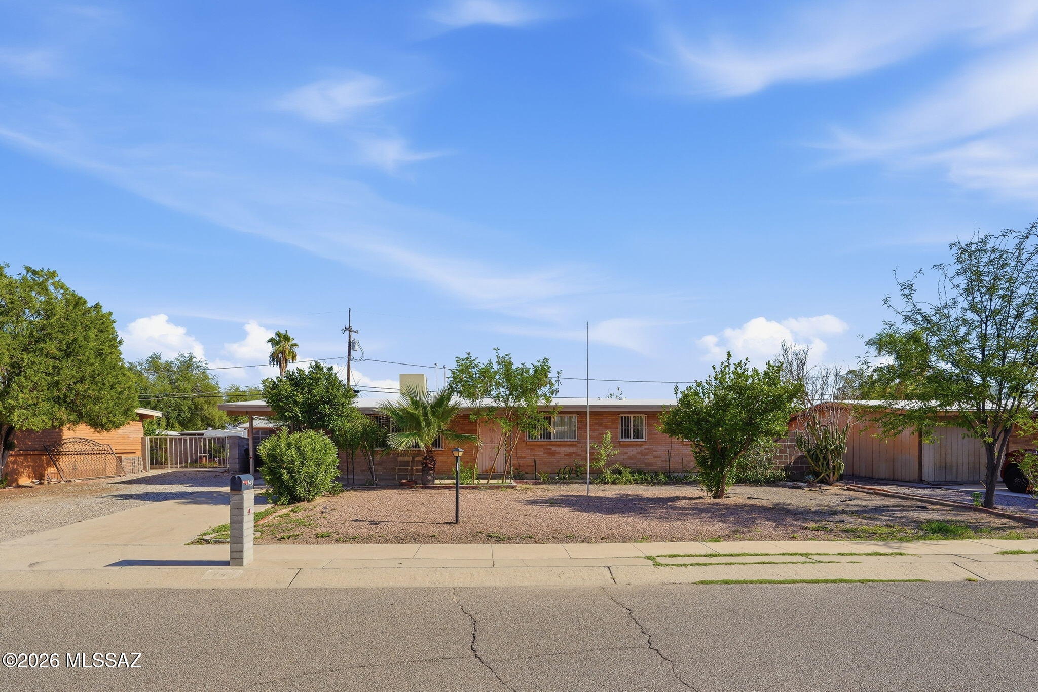 Charming Ranch Style home with 4 bedrooms and 2 baths located in the Northwest Tucson area.  Home features: 1,485 square feet of living space, spacious kitchen with plenty of cabinets. Corian kitchen counter tops, dining area. Ceiling fans throughout. Large fenced backyard with shed and small workshop. Covered patio.  The primary bedroom is spacious and has 2 closets. Single carport with storage. NO HOA.