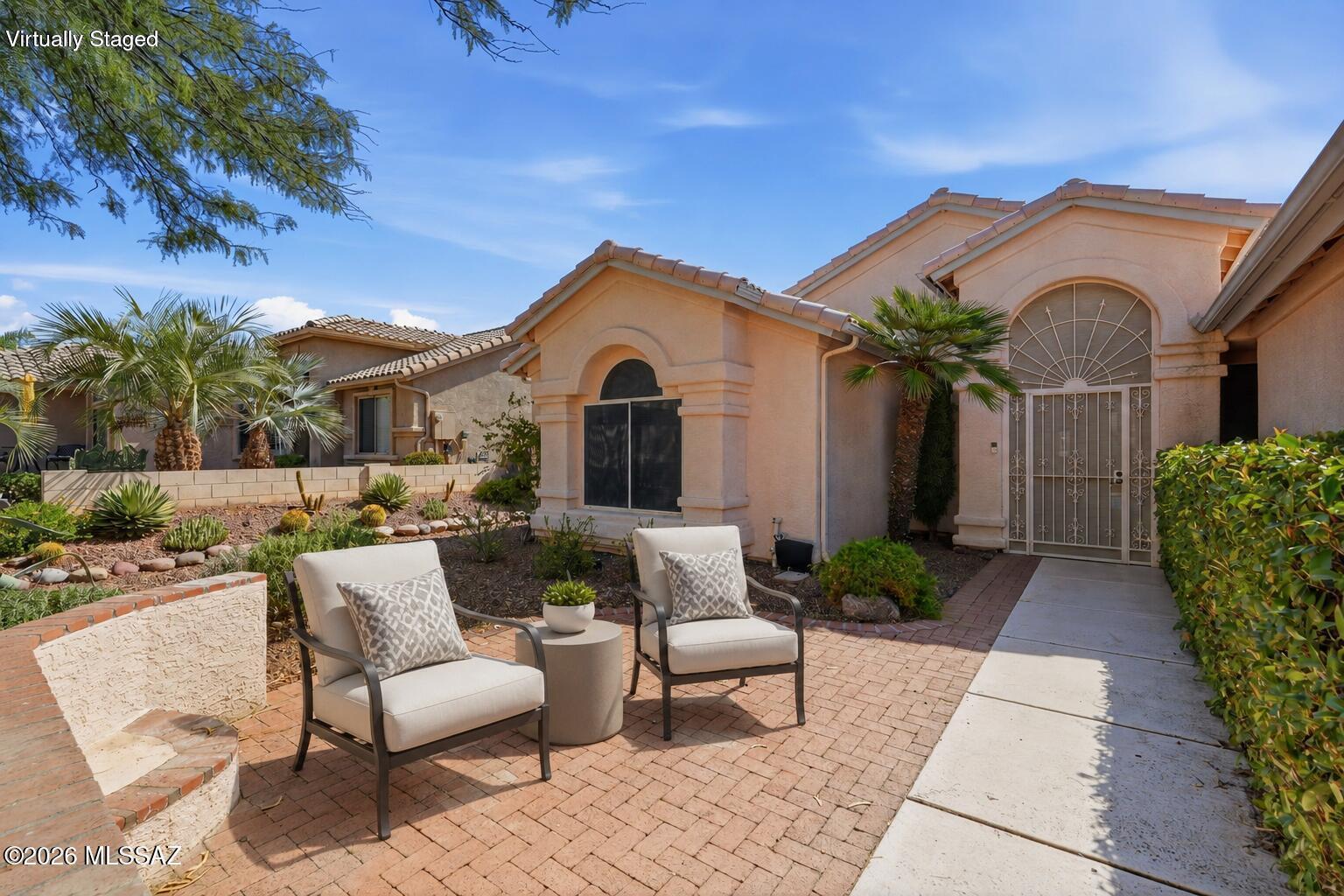 This lovely Madera floorplan is located in the highly sought-after SaddleBrooke community. This beautifully maintained 2-bedroom + den, 2.5-bath home offers an open floor plan with high ceilings and neutral ceramic tile throughout. The bright kitchen features abundant cabinetry and generous counter space, flowing seamlessly into the spacious living and dining areas. The large primary suite includes dual vanities, a walk-in shower, and a relaxing soaking tub. Step outside to a covered patio with ceiling fans, and AMAZING MOUNTAIN VIEWS, surrounded by mature desert landscaping. A front courtyard and security gate adds convenience. Enjoy SaddleBrooke's exceptional amenities, including golf, fitness centers, pools, dining, and an active resort-style lifestyle.