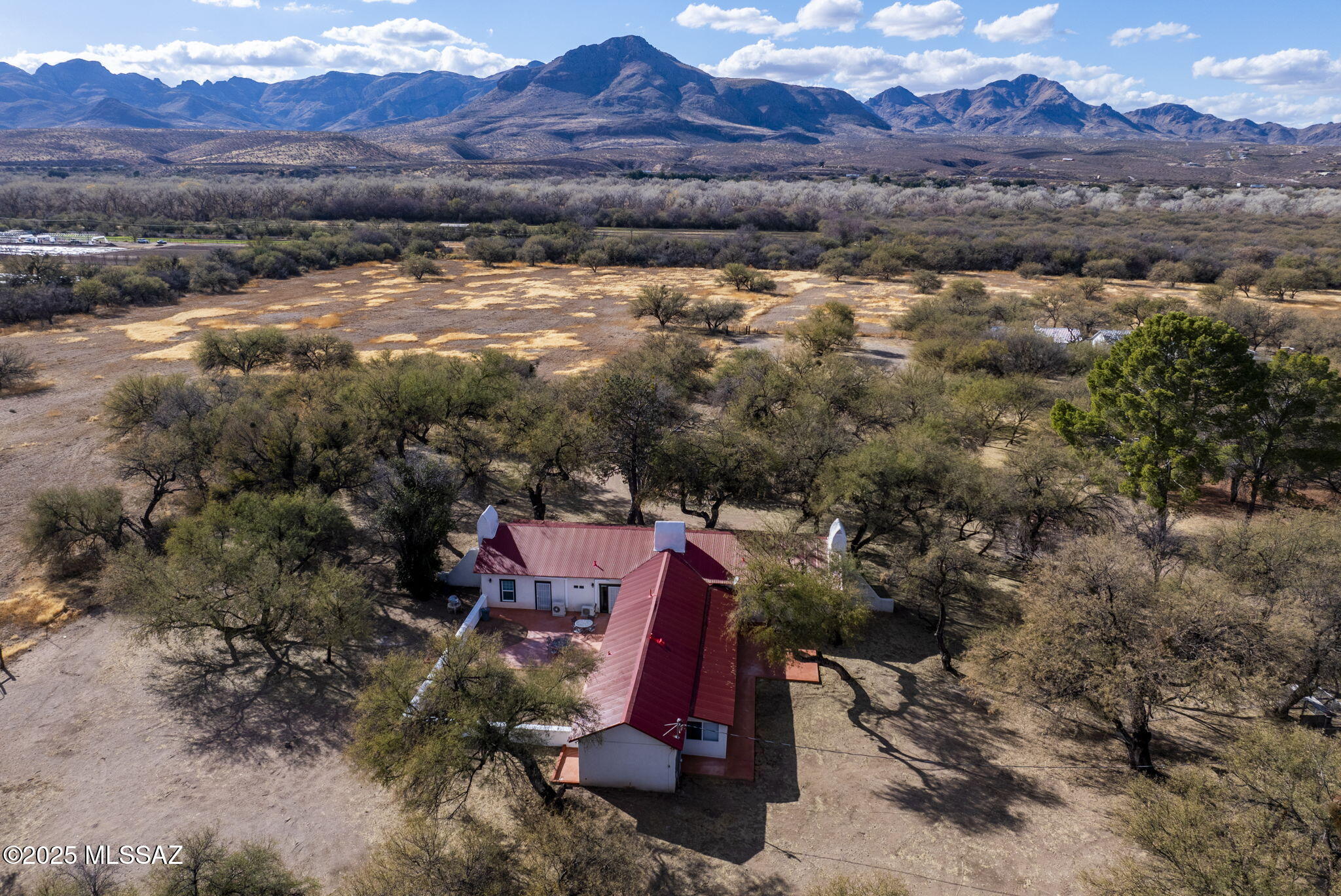 Nestled on 525 acres which includes irrigated pastures as well as land in the foothills overlooking the Santa Cruz River Valley,  the historic Slash J Ranch offers a rare opportunity for ranching enthusiasts, investors, or anyone seeking a tranquil, expansive retreat or working ranch. The property boasts four distinct homes, several of which date back to the 1880s, and all of which have been totally renovated, yet keeping the original historic style. These structures  include a charming casita and a private studio as well as the main house offering three bedrooms, three baths, and three fireplaces as well as a bright and open country kitchen. There are several versatile living spaces on the ranch for family, guests, or potential rental income. (see more)
