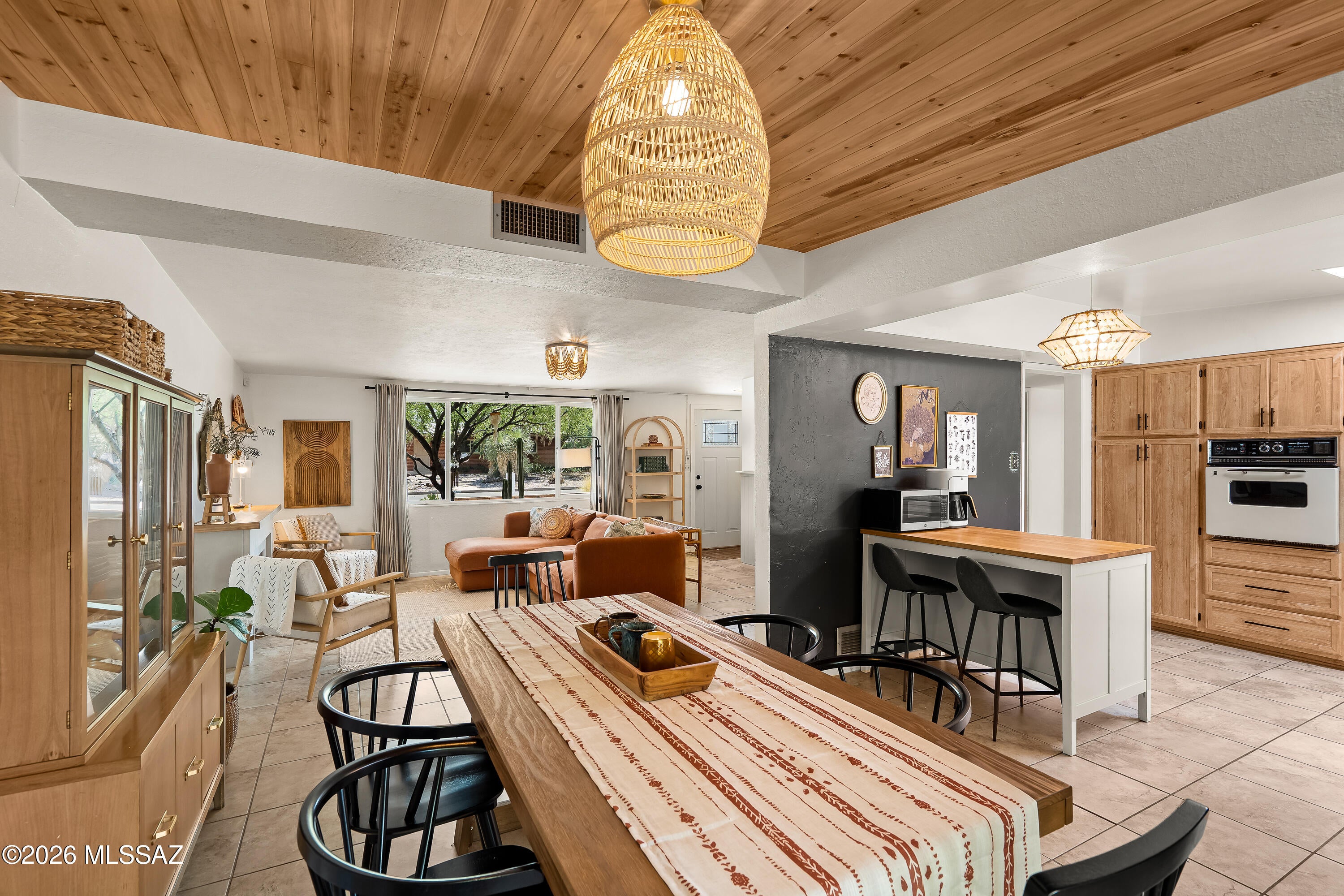 This classic Tucson adobe ranch home has three-bedrooms, two-bathrooms. It pairs mid-century character with a thoughtful series of recent improvements and an abundance of usable and stylish spaces. Exposed adobe walls, bohemian accents, and a wood ceiling in the dining room add warmth and architectural interest, while tile and wood laminate flooring run throughout the home.
The kitchen features an updated cooktop and range hood, with new hardware and light fixtures adding a fresh touch throughout the home. The spacious laundry room/office, complete with a bonus pantry, offers exceptional storage and flexibility. A heated and cooled Arizona room extends the living space and provides another comfortable area for year-round use.
Recent improvements include a new roof and skylights in 2023, new paver patio and turf in 2024, an upgraded back door, and updated windows throughout. Nemerous improvements in the dining room and living room further refresh the interior. Shutter shades on all bedroom windows add privacy and light control.
The outdoor spaces offer room to entertain, garden, and create. A new paver patio and turf lawn provide an inviting setting, while a large bonus yard offers space for gardening or other hobbies, with room for a future ADU or pool. A water-harvesting system with tank, additional carport and workshop space, and a one-car garage add practical value.
With its combination of distinctive mid-century details, generous storage, flexible spaces, and meaningful recent improvements, this home offers an appealing blend of character and everyday functionality.
Less than 5 miles from the University of Arizona, 4 miles from Davis Monthan AFB, and 2 miles from Tucson Medical Center.