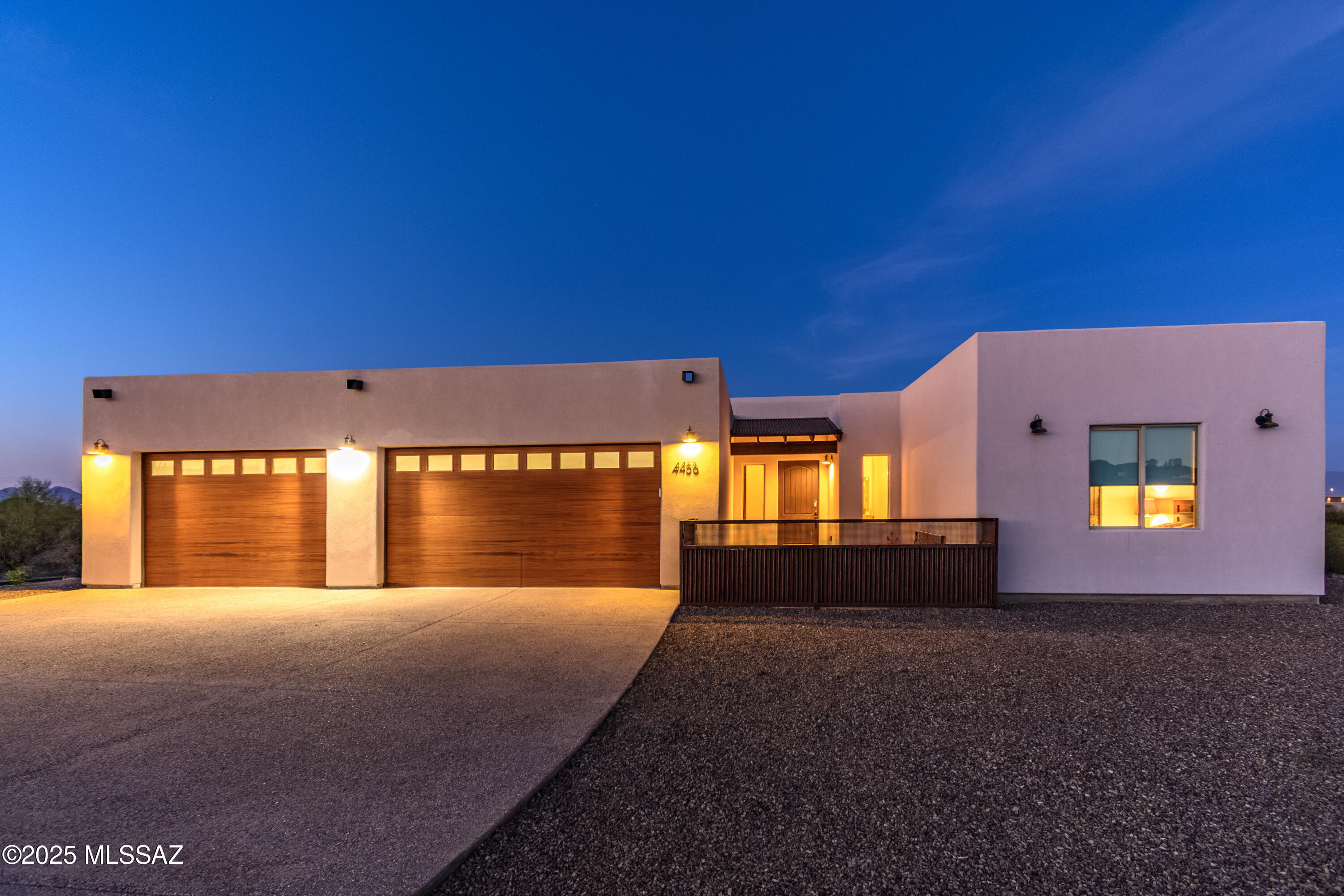 Desert elegance meets elevated living in this beautifully designed  3-bedroom, 2-bath residence set on 1.3 private acres within an exclusive gated enclave on Tucson's west side. Surrounded by sweeping mountain views and shimmering city lights, this home offers a rare blend of privacy, design, and the tranquil beauty of the Sonoran Desert. From the moment you step inside, soaring ceilings and expansive walls of glass fill the home with natural light, creating a seamless connection between indoor living and the surrounding landscape. The open-concept layout is both inviting and functional, anchored by a dramatic great room featuring a custom entertainment wall and sleek electric fireplace--perfectly suited for both relaxed evenings and elevated entertaining. At the heart of the home, the chef's kitchen impresses with smart appliances, custom cabinetry, granite countertops, and an oversized island designed to bring people together. Whether hosting guests or enjoying a quiet night in, this space delivers both style and practicality.

Privately positioned, the primary suite offers a true retreat with dual walk-in closets and a spa-inspired bath complete with dual vanities, a soaking tub, and a spacious walk-in shower. Two additional bedrooms provide flexibility for guests, a home office, or creative space--each thoughtfully designed to complement the home's modern desert aesthetic.

Step outside and experience what truly sets this property apart. The resort-style backyard is designed for both relaxation and unforgettable entertaining, featuring a sparkling pool with in-water seating and swim-up bar, a tranquil spillover spa, outdoor kitchen with built-in BBQ, travertine decking, a professional-grade putting green, and multiple covered seating areas--all framed by expansive desert views and open skies.

Tucked away in a peaceful, upscale community yet just minutes from premier dining, shopping, golf, and outdoor recreation, this home offers the perfect balance of seclusion and convenience.

This is more than a home--it's your private desert escape.