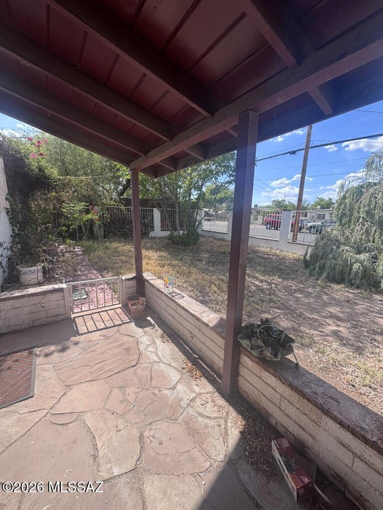 Fix-up property oozing with charm and character, located just minutes from the U of A. Great bones and endless upside! The main house features 2 bedrooms, 1 full bath, and wood beam ceilings with a gorgeous beehive fireplace. The permitted guest house includes 1 bedroom and a half bath (previously used as an office), bringing the total combined square footage to approximately 680 sq. ft.  Fully fenced with a block wall, mature trees, a fountain, and a gazebo that stays. There is truly nothing like this on the market--what an amazing value, come see for yourself!