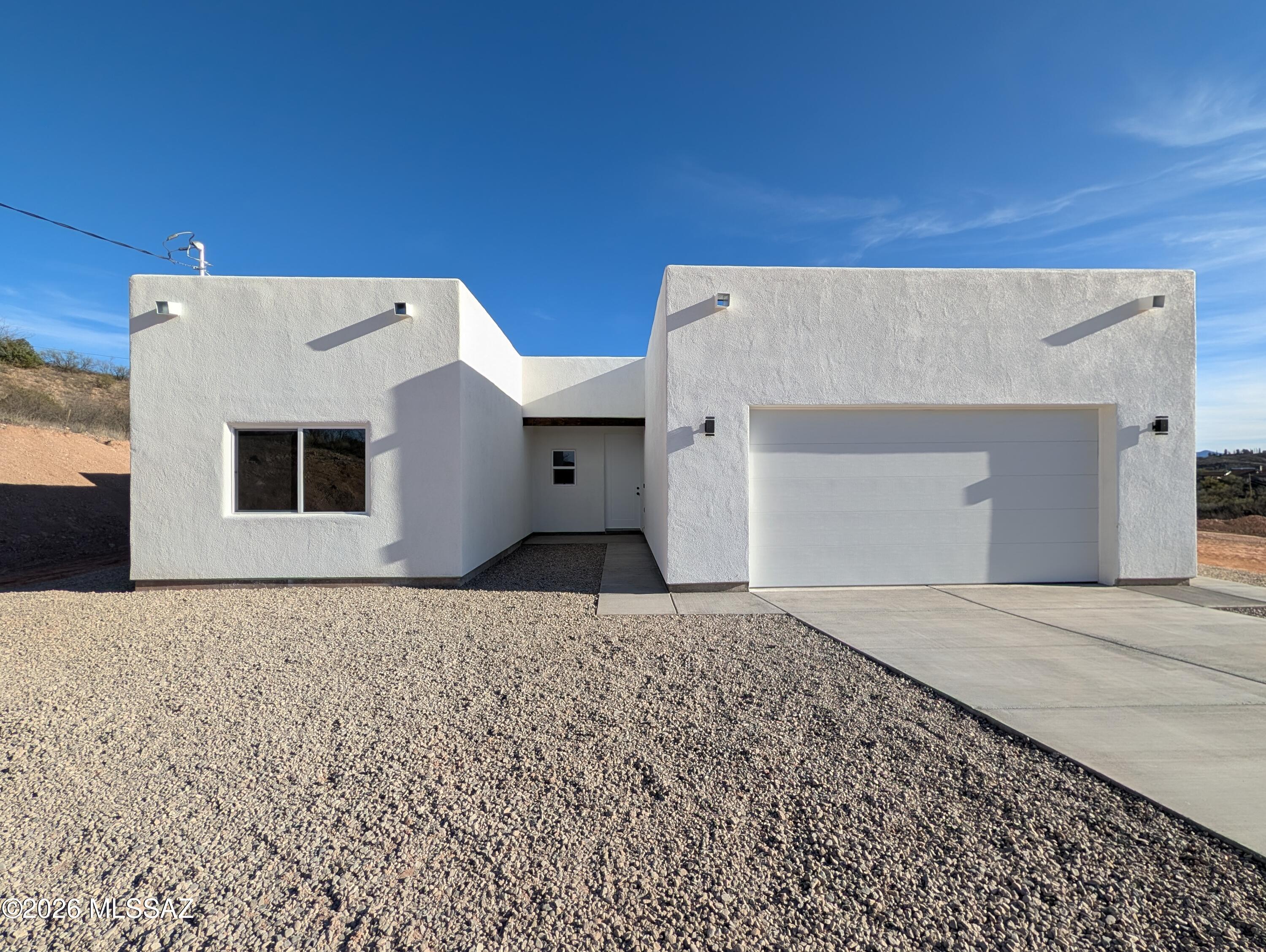 New construction on over half an acre with beautiful mountain and sunset views! This move-in ready home features a bright open floor plan with ceramic tile throughout. The custom kitchen offers quartz countertops, upgraded cabinetry, and a spacious walk-in pantry. The primary suite includes a walk-in closet, tiled shower, and modern floating vanity for a sleek contemporary feel. Enjoy outdoor living on the covered porch and the convenience of a 2-car garage with an 8-foot door. The expansive lot has been cleared into two separate levels, providing endless possibilities for entertaining, additional structures, or creating your ideal backyard retreat.