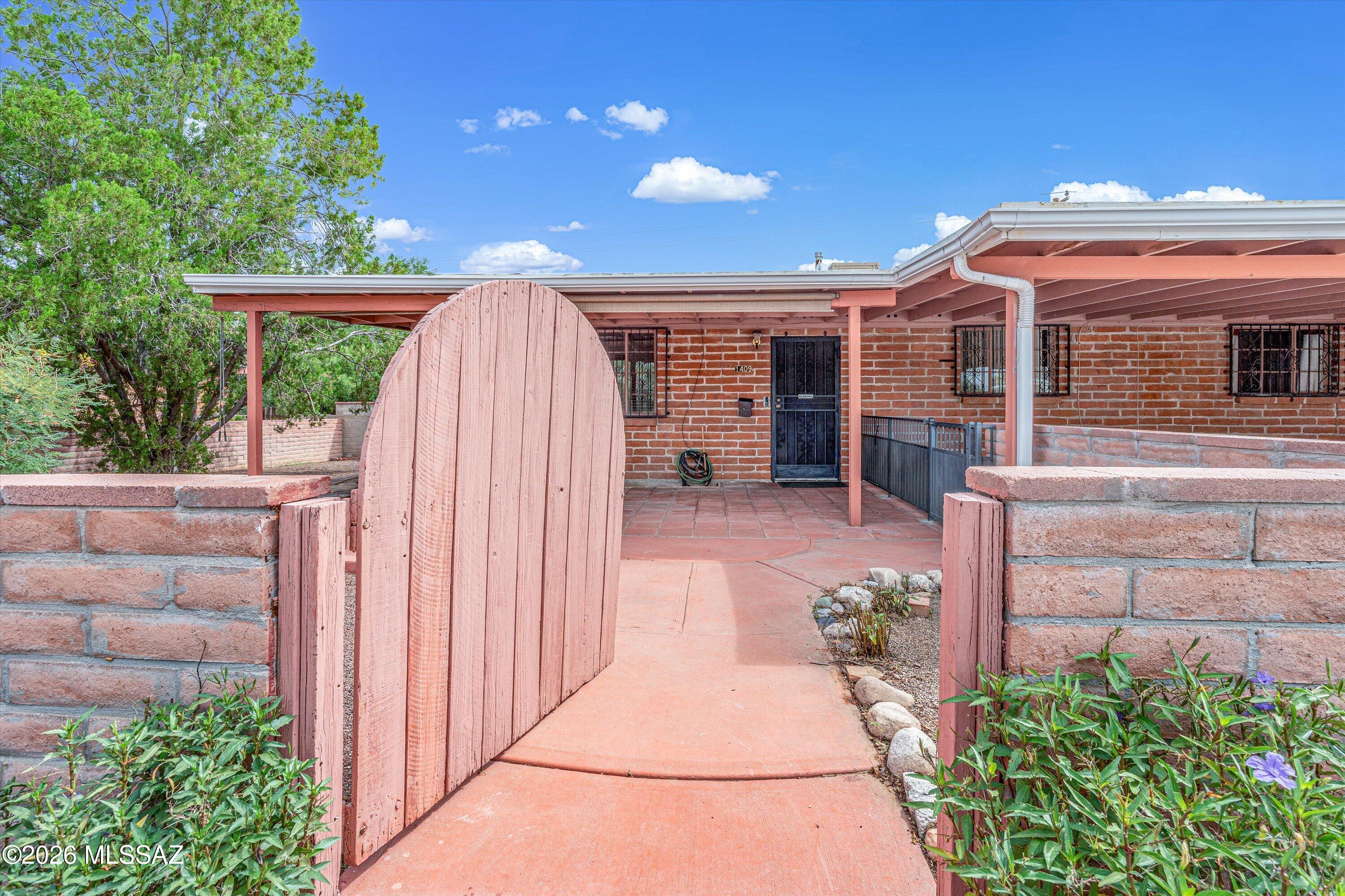 Welcome home to this classic Eastside ranch where timeless Southwest character meets space, versatility & NO HOA! Quality adobe block construction, a cozy wood-burning fireplace, built-in desk & spacious enclosed Arizona room add to the charm. Outside, enjoy a welcoming front courtyard, mature landscaping, generous lot with full masonry perimeter wall, 2-car carport, TWO workshop areas & plenty of room for your toys! Recent updates include a newer water heater and roof, both updated within the past few years, fresh interior/exterior paint & trim, refreshed kitchen hardware & updated GFCIs. Water filtration system already in place, plus Vivint alarm system with option to lease. Convenient Eastside location near Davis-Monthan AFB, shopping, dining & major employers!