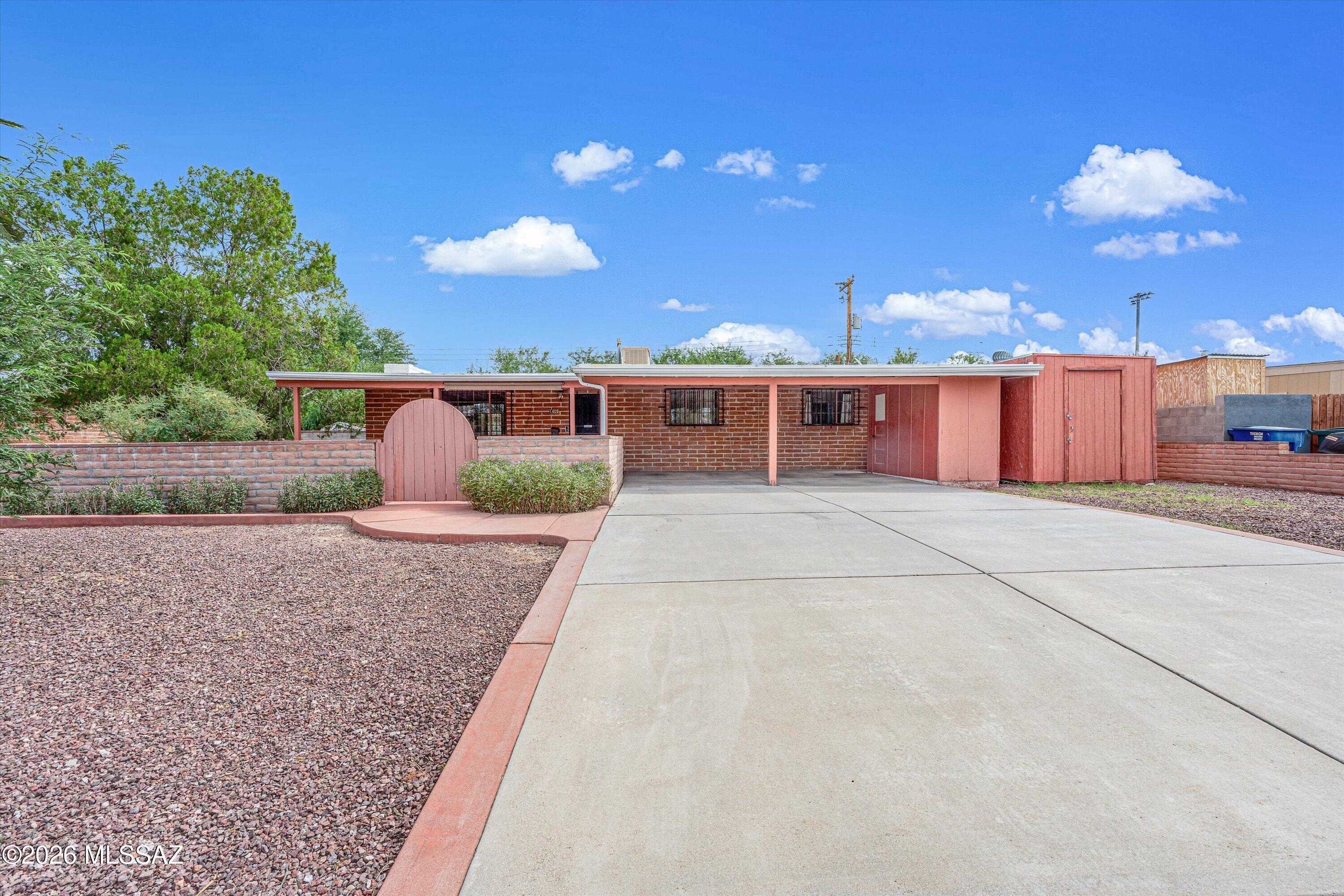 Welcome home to this classic Eastside ranch where timeless Southwest character meets space, versatility & NO HOA! Quality adobe block construction, a cozy wood-burning fireplace, built-in desk & spacious enclosed Arizona room add to the charm. Outside, enjoy a welcoming front courtyard, mature landscaping, generous lot with full masonry perimeter wall, 2-car carport, TWO workshop areas & plenty of room for your toys! Recent updates include a newer water heater and roof, both updated within the past few years, fresh interior/exterior paint & trim, refreshed kitchen hardware & updated GFCIs. Water filtration system already in place, plus Vivint alarm system with option to lease. Convenient Eastside location near Davis-Monthan AFB, shopping, dining & major employers!