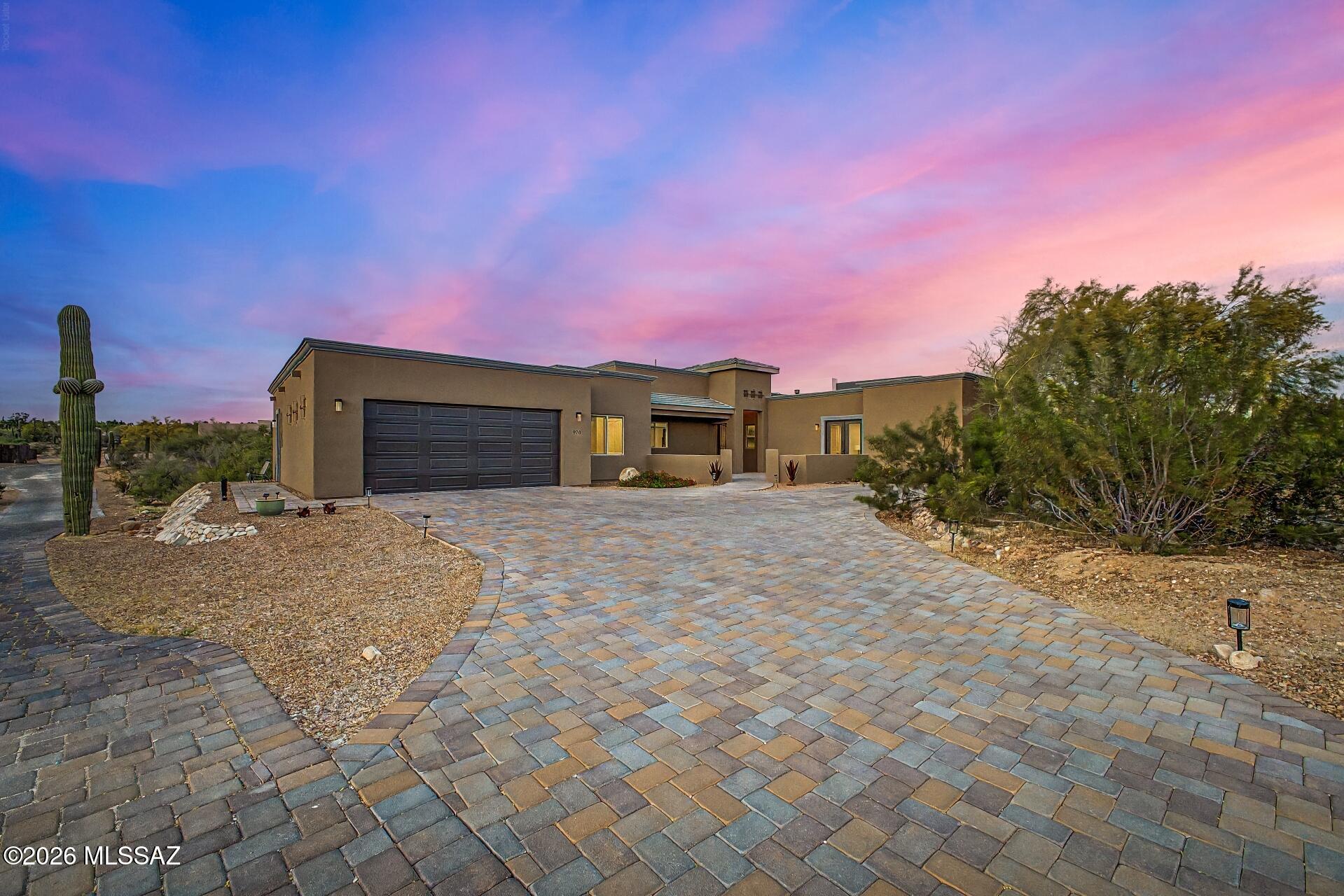 Like-new custom 4-bed home with private casita and mountain views in a gated community. This stunning, practically brand- new 4-bed, 3.5-bath custom home sits on nearly 1 acre in a private gated enclave of custom homes. NO HOA. Built in 2023 and beautifully maintained, it features gray-dyed concrete floors, custom mocha cabinetry, oil-rubbed bronze and black fixtures, and soaring ceilings. Large windows frame out the Catalina mountain and nature views. Chef's kitchen with massive island, stainless appliances, and walk-in pantry. Luxurious primary suite with courtyard access. Private casita with a full bath & kitchenette. Perfect for guests or the quiet ideal home office! 3-car garage with pass-through door, huge laundry, two extra large storage closets and even a small bonus hobby or office space. Paver patio and courtyard!