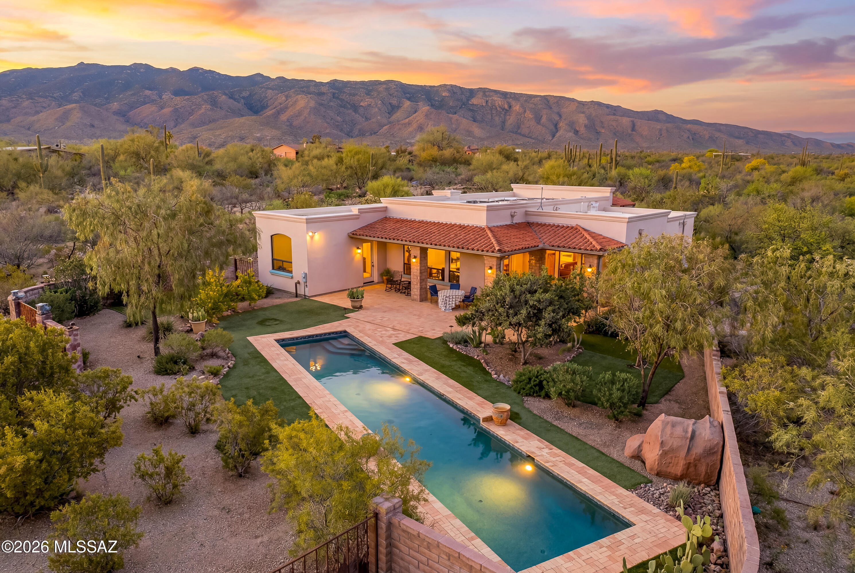 2016 Modern Spanish Revival on PRIVATE,  LUSH parcel. 2x8 & Masonry!12ft Rough Sawn Beam& Plank Ceilings. Timeless& Authentic in Every Detail. Fluted Cantera Gas Fireplace; Artisan Crafted Cabinetry; Soapstone Counters; Blonde Brick Floors. Each Finish Chosen to Last a Lifetime. Nestled in The Notch - a NE Enclave Bordered 2 sides by NTL. PARK! Hike/Ride from the Barn to multiple trailheads. 1/2mi to the nearest Neighborhood Park Access! TRAVERSE 128 MILES of Desert Vistas, Mesquite Bosques & RIDE into the Mtns. The Open-Concept Draws the Landscape In via Expansive MTN-FACING Windows Shaded by Wrap-Around, Beamed Patio. Walled Courtyard& Large Backyard, Turf& 50ft LAP/GAME POOL. Turnkey Stable. Steel Shop. RV Hook-UP! City Water. County Rd Maint. No HOA. Full Spec List Avail. Owner/Agent.