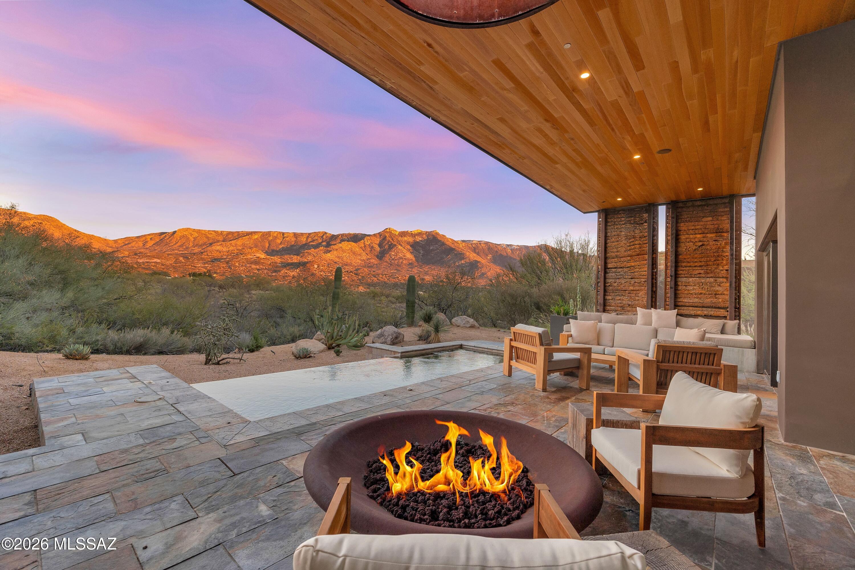 Welcome to your private wellness sanctuary, tucked away in a small enclave of homes on the grounds of MIRAVAL Resort in Tucson, AZ. This residence and this lifestyle are distinctly different. Here, you hit the pause button and recharge. With the amenities of a world class destination spa at your doorstep, it's easy to do. Created by the forward-thinking minds at MITHUN of Seattle, this home intentionally feels subdued from the approach, while offering a powerful experience upon entering. Blending with the earth and honoring the desert were top of mind for a sustainable build. Awarded Silver LEED status from the Green Building Council, the property integrates materials, textures and colors that speak to the surrounding landscape. Seamlessly blending indoors and out, with unobstructed views of the Catalina Mountains, this setting invites you to relax, breathe and connect with nature. Layers of the desert unveil themselves as light moves throughout the day. This is truly a place that allows the mind to clear and opens space for creative thoughts.

A thoughtful layout offers the ability to comfortably host guests or delineate spaces for different functions. The 2400 sq ft main house includes the primary suite, guest bedroom, guest bath and great room flowing to an expansive patio from which you feel completely secluded. With a gas fire pit, infinity plunge pool with swim jets and outdoor daybed, this area adds substantial living space to the home. A 700 sq ft detached casita provides a private setting for guests with separate living and rest spaces, ensuite bath and courtyard with a jetted spa.

Homeowners and their guests may choose to immerse themselves in the experiences at MIRAVAL as little or as much as they desire. The resort has created an environment in which a wellness journey is completely individual and offers a robust variety of facilities, services, and activities. A sampling of offerings includes spa treatments, fitness classes, yoga, meditation, hiking, mountain biking, equine therapy and horseback riding, lectures, culinary classes, and spiritual sessions. With on-site dining, concierge and transportation services, everything needed is at your fingertips.

A unique and easy to own asset, this property would work beautifully as a vacation home, seasonal residence, or corporate retreat. There is the option to rent the property through the resort-managed rental program when unoccupied, if desired.