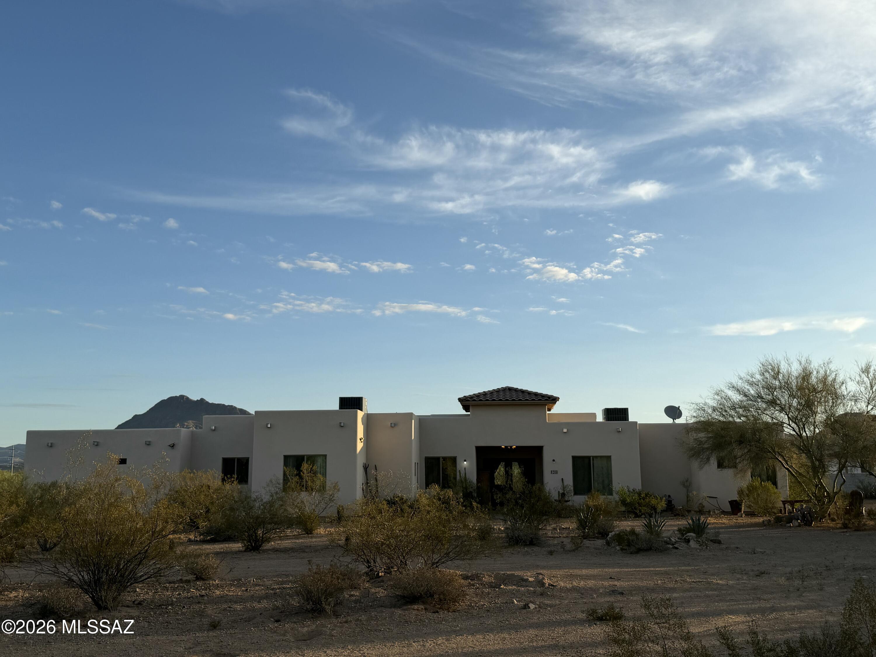 Experience breathtaking mountain views and the beauty of the Sonoran Desert right from your own backyard. Nestled on 3.63 private acres, this stunning Santa Fe-style home offers the perfect blend of luxury, privacy, and authentic Tucson charm. Enjoy your morning coffee surrounded by peaceful desert wildlife, immersed in the tranquility of the desert. Built in 2021, this elegant 3,100 sq ft home features thoughtfully designed living space with high ceilings and abundant natural light. The open-concept layout creates an inviting atmosphere, spacious kitchen flows seamlessly into the spacious main living area--perfect for both entertaining and everyday comfort.
Offering 4 spacious bedrooms, 2.5 bathrooms, and a versatile bonus room ideal for a home office,