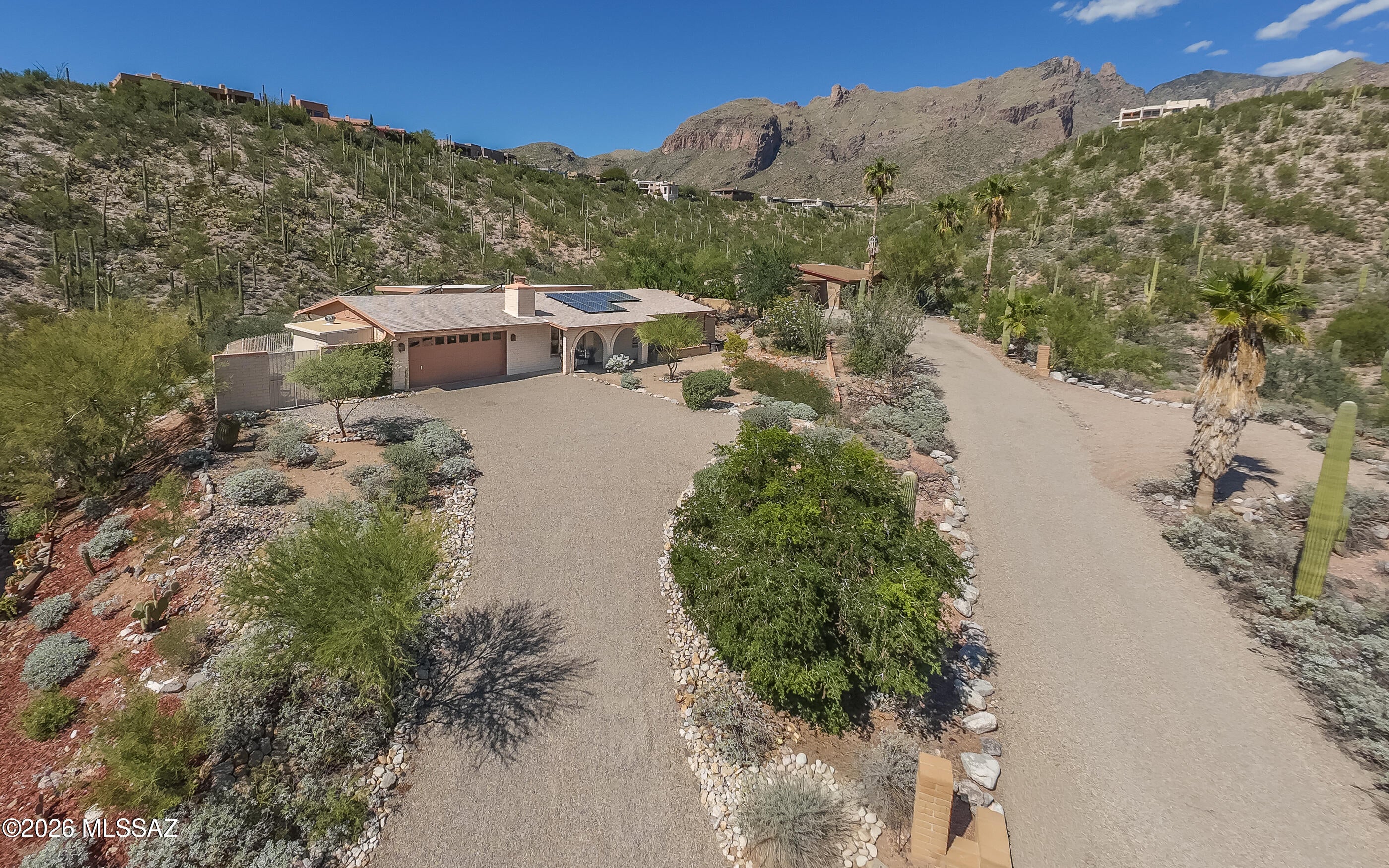 Come see this lovely home with its peaceful, private setting, its city, mountain, saguaro and Finger Rock views, and its efficient & functional floorplan. Enjoy comfort and energy-efficiency with Pella Windows, extra-tall Milgard low-e sliders, 7.2kw of Sunpower Owned/paid-off Solar electricity with Tesla Powerwall battery, 5-year-old shingle roof, and two 15-SEER American Standard HVACs (6&8yo). Live large in the efficient split-bedroom floorplan with the kitchen at the heart of it. Ceramic tile flows throughout, with new carpet in the bedrooms. Soak up the vistas and serenity from an elevated .37-acre lot with acres and acres of HOA-owned land both behind and across the street allowing for incredible privacy. This home proves you don't have to own the entire Back Forty to enjoy it!