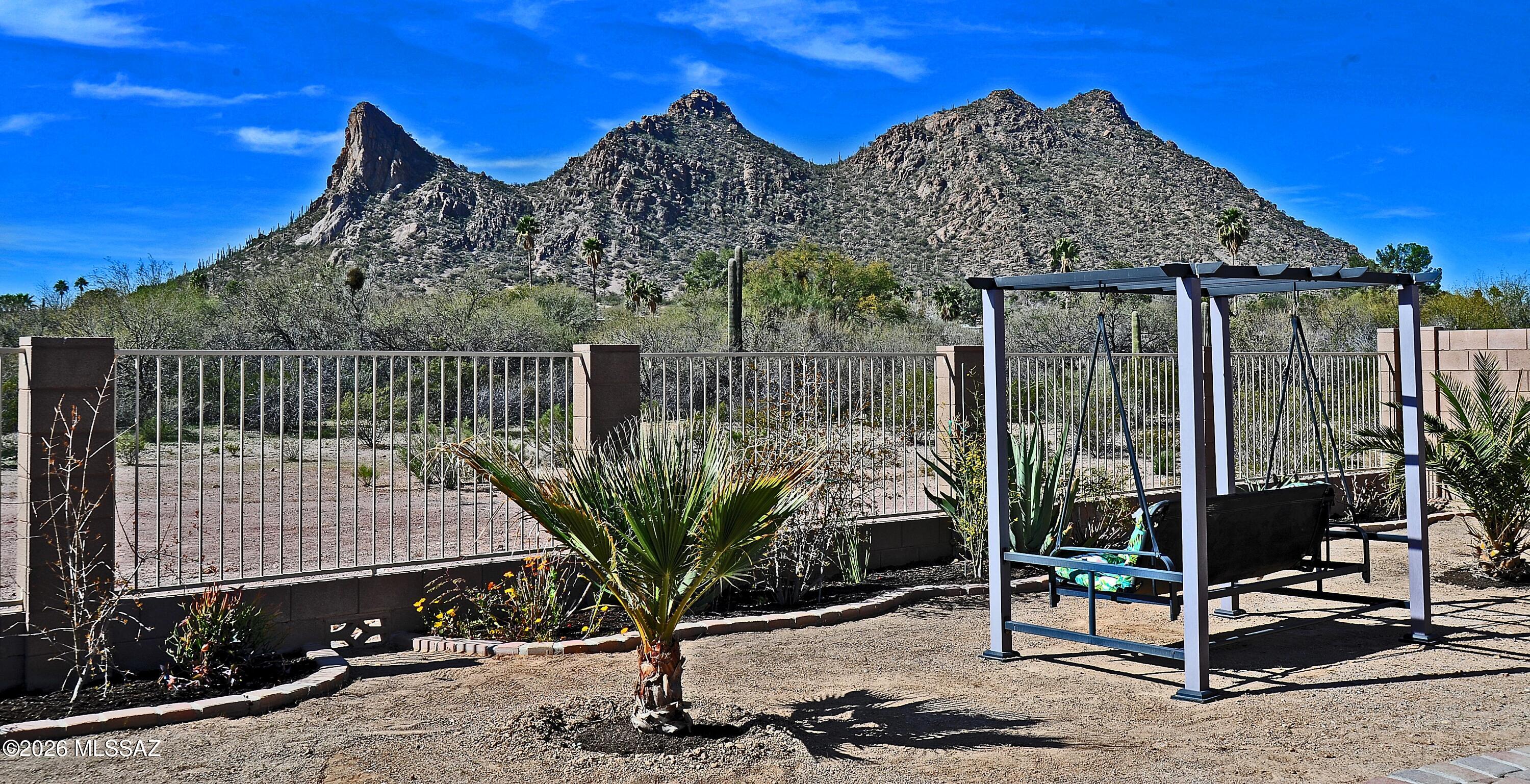 Range Price 300,000-315,000. 

Built in 2019 and situated on a quiet cul-de-sac, this single-story home offers a smart layout, modern finishes, and a backyard setting that truly stands out.

Ceramic tile flooring runs throughout, creating a cohesive and low-maintenance living space. The open-concept living and dining areas flow naturally into the kitchen, making everyday living simple and connected. The kitchen features dark cabinetry, light countertops, stainless appliances, and a gas range. 

Large sliding glass doors bring in natural light and frame peaceful desert and mountain views. A versatile open den provides flexible space for a home office or media room, or it can easily be enclosed to create a third bedroom. The primary suite feels bright and private, with mountain views from the window and a spacious bathroom complete with dual vanities, ample cabinetry, and a dual shower/tub combination.

Step outside to a backyard that backs to a natural desert wash, offering privacy, open space, and unobstructed mountain views. The extended paver patio creates a comfortable area to relax or entertain while keeping the yard low maintenance.

Additional features include a two-car garage, Home Energy Performance construction for improved efficiency, and a desirable single-story design within an HOA community.

Clean, functional, and positioned for privacy -- this home delivers comfort, views, and a setting that's hard to duplicate.