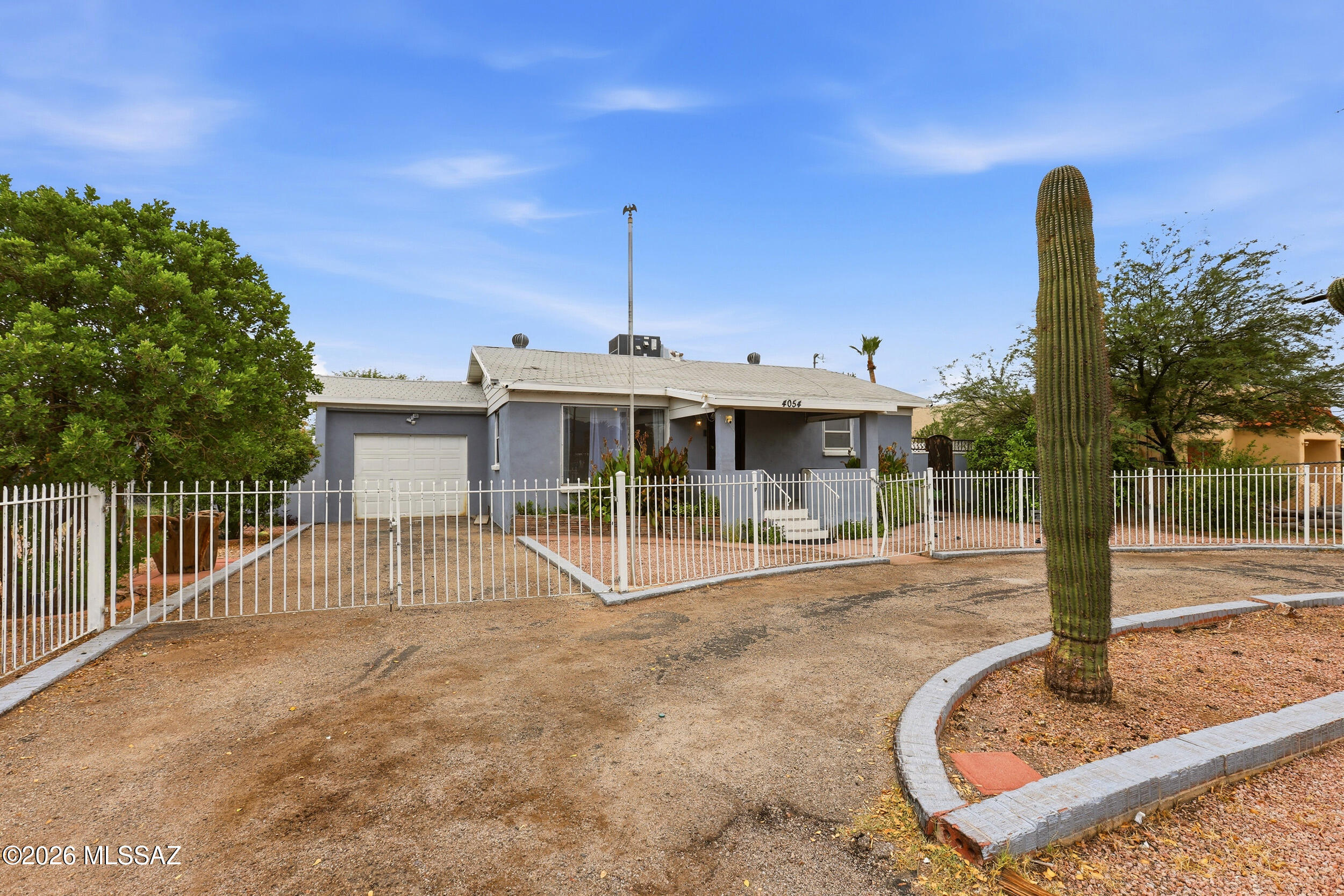 Centrally located and full of character, this 1955 home offers the rare combination of an updated main residence plus spacious, fully equipped guest quarters. The approximately 1,220 sq. ft. main home features 2 bedrooms and 1 bathroom, beautifully preserved original hardwood floors, and remodeled kitchen and bath spaces that blend modern updates with the home's mid-century charm.

The approximately 800 sq. ft. guest quarters offers exceptional flexibility with its own bedroom, bathroom, living area and full kitchen--ideal for extended family, guests, a home office or additional living space.

Major improvements add even more value, including remodeled kitchens and bathrooms, new tile flooring, replacement of the home's original galvanized plumbing with updated piping a brand-new HVAC system serving the guest quarters and an approximately five-year-old HVAC system in the main home.

Conveniently located near shopping, dining, medical facilities and everyday amenities, this property offers approximately 2,020 sq. ft. of combined living space with a versatile two-residence setup that's increasingly hard to find in Central Tucson.