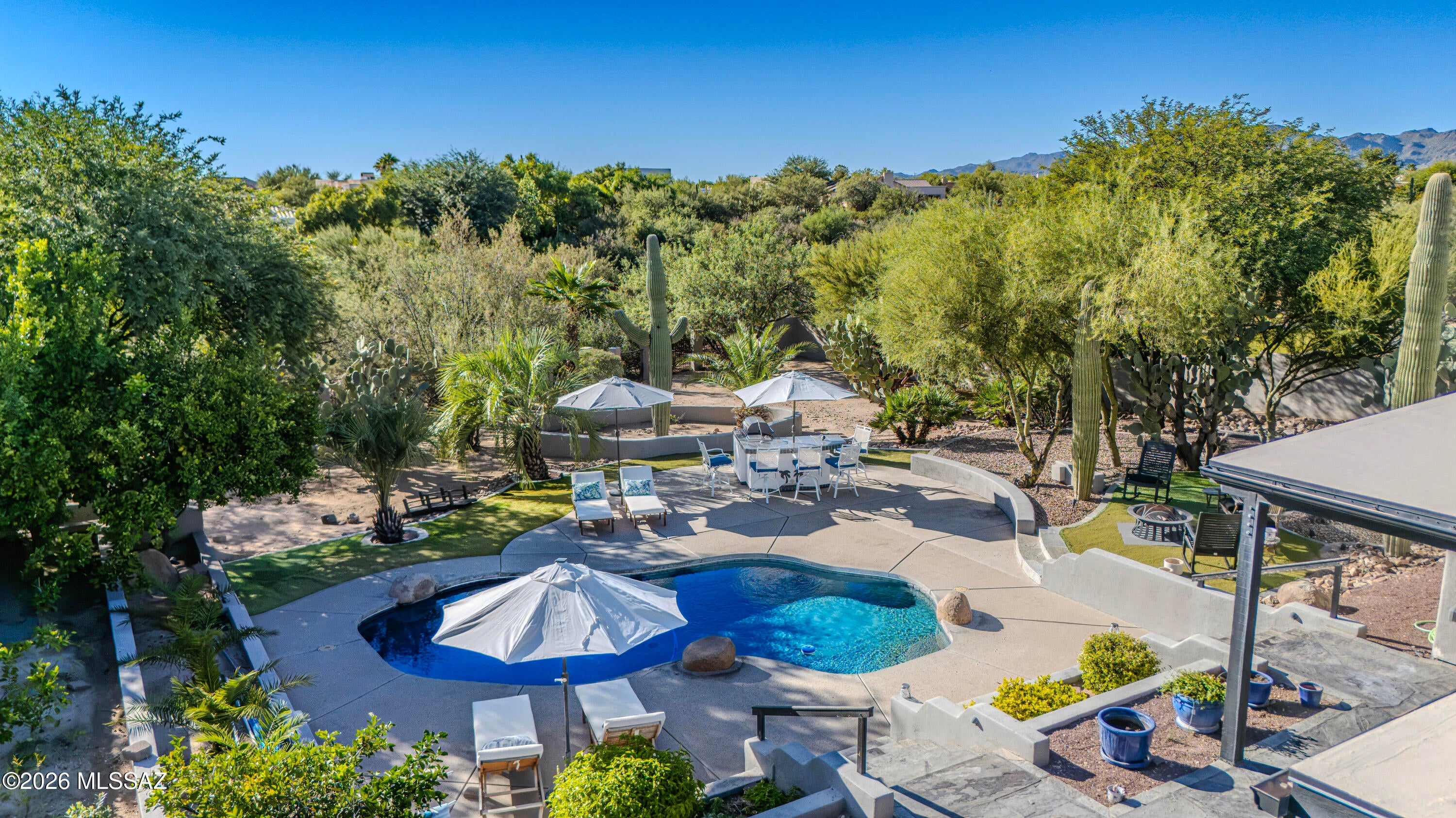 Welcome to this beautifully maintained Oro Valley home on a spacious half-acre lot. The desirable split-bedroom floorplan features a private primary suite and three additional bedrooms. The renovated kitchen offers a large island, abundant cabinetry, and generous counter space, opening to a spacious great room with a gas fireplace. Step outside to a private backyard with a sparkling pool, built-in BBQ, turf, and plenty of space for entertaining, relaxing, and play. With an open layout, updated kitchen, pool, and expansive outdoor living space, this home offers comfortable Arizona living in a sought-after Oro Valley setting.
