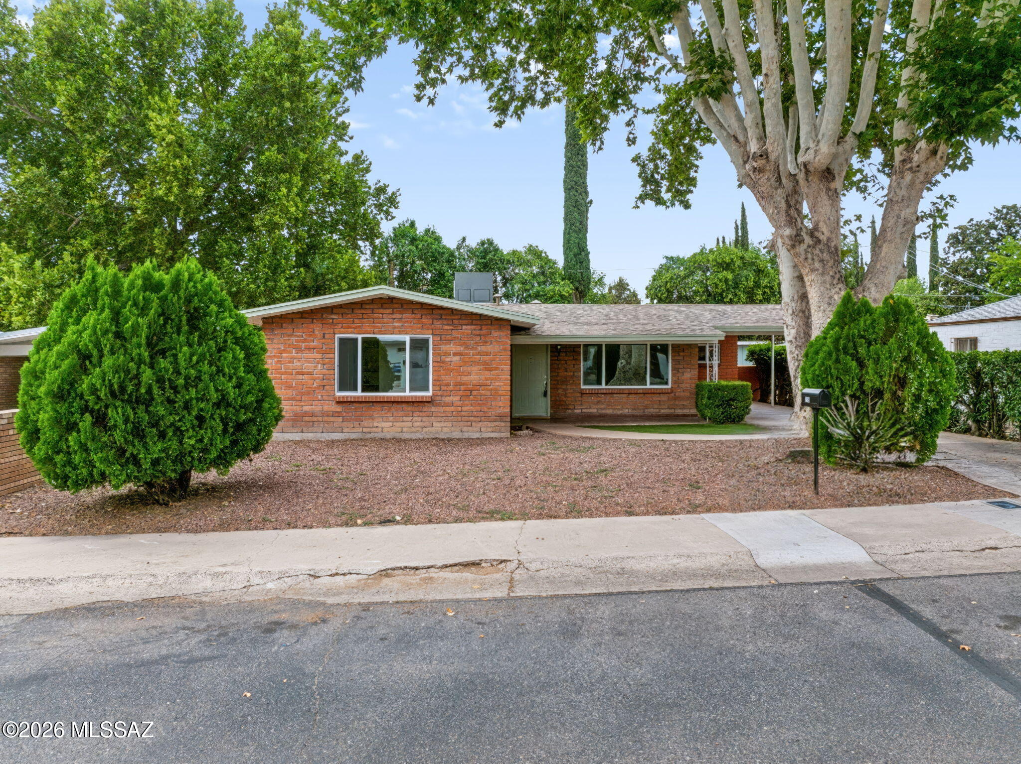 Welcome to 215 W. Kolver Street, a beautifully updated home situated in the established and coveted Villa Coronado neighborhood of Nogales, offering an ideal blend of classic character, modern improvements, and a convenient central location.

The home has been extensively updated throughout, featuring a new roof, HVAC system, and electrical panel, along with upgraded dual-pane windows and fresh interior and exterior paint.
 
Inside, the home is bright and inviting, with fresh neutral finishes and multiple spacious living areas. A separate living room provides a comfortable gathering space, while the expansive great room is highlighted by a wood-burning fireplace, adding warmth and character to the home. The beautifully remodeled kitchen features contemporary gray cabinetry, updated countertops, stainless-steel appliances, abundant storage, and natural light from an overhead skylight.

The bathrooms have also been refreshed with modern vanities, fixtures and attractive tile surrounds, including a walk-in tiled shower. Built-in cabinetry throughout the home provides additional character and practical storage. 

Located within the carport area, a dedicated laundry room offers added functionality with a utility sink and built-in cabinetry for convenient storage and organization. A covered outdoor area further extends the home's usable living space and provides a comfortable setting for relaxing or entertaining.

Outside, mature landscaping and established trees provide shade and character while complementing the home's classic brick exterior. Conveniently located near City Hall Park and A.J. Mitchell Elementary School, the property also offers easy access to shopping, dining, and other community amenities.

With extensive improvements already completed, versatile living spaces, and a clean, updated interior, 215 W. Kolver Street is move-in ready and waiting for its next owner to call it home.