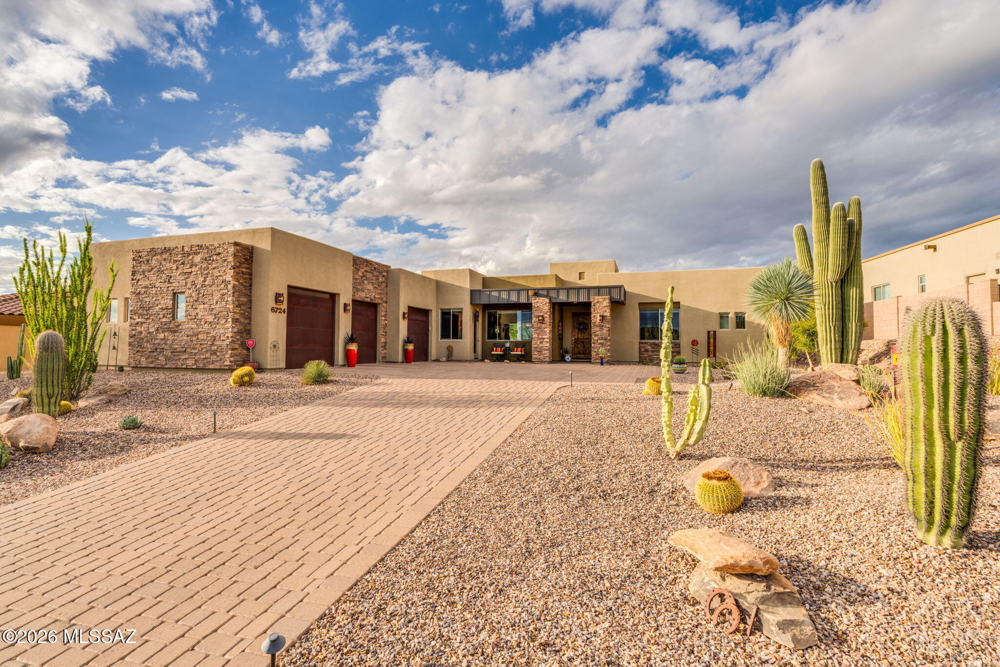 Perched along the first fairway of the Saguaro Course in Dove Mountain, this exceptional 3-bedroom, 3.5-bath residence with den offers a rare combination of sweeping mountain views, beautiful indoor-outdoor living, and an extraordinary setting. From the moment you enter, expansive views draw your eye across the golf course to the mountains beyond, immediately showcasing what makes this lot so special. The thoughtfully designed interior is warm, inviting, and exceptionally well cared for. At the heart of the home is a dream kitchen featuring beautiful cabinetry with soft-close pull-outs and luxurious quartzite countertops, creating a space that is as functional as it is beautiful. The kitchen opens naturally to the living areas, making it ideal for both everyday living and entertaining. Outside, the home truly shines. A stunning pool and spa are surrounded by exceptional, mature landscaping that creates a private resort-like atmosphere and beautifully complements the surrounding Sonoran Desert. The outdoor living experience is enhanced by Sonos speakers making this an effortless place to relax and entertain while enjoying the spectacular backdrop. The best of Dove Mountain living