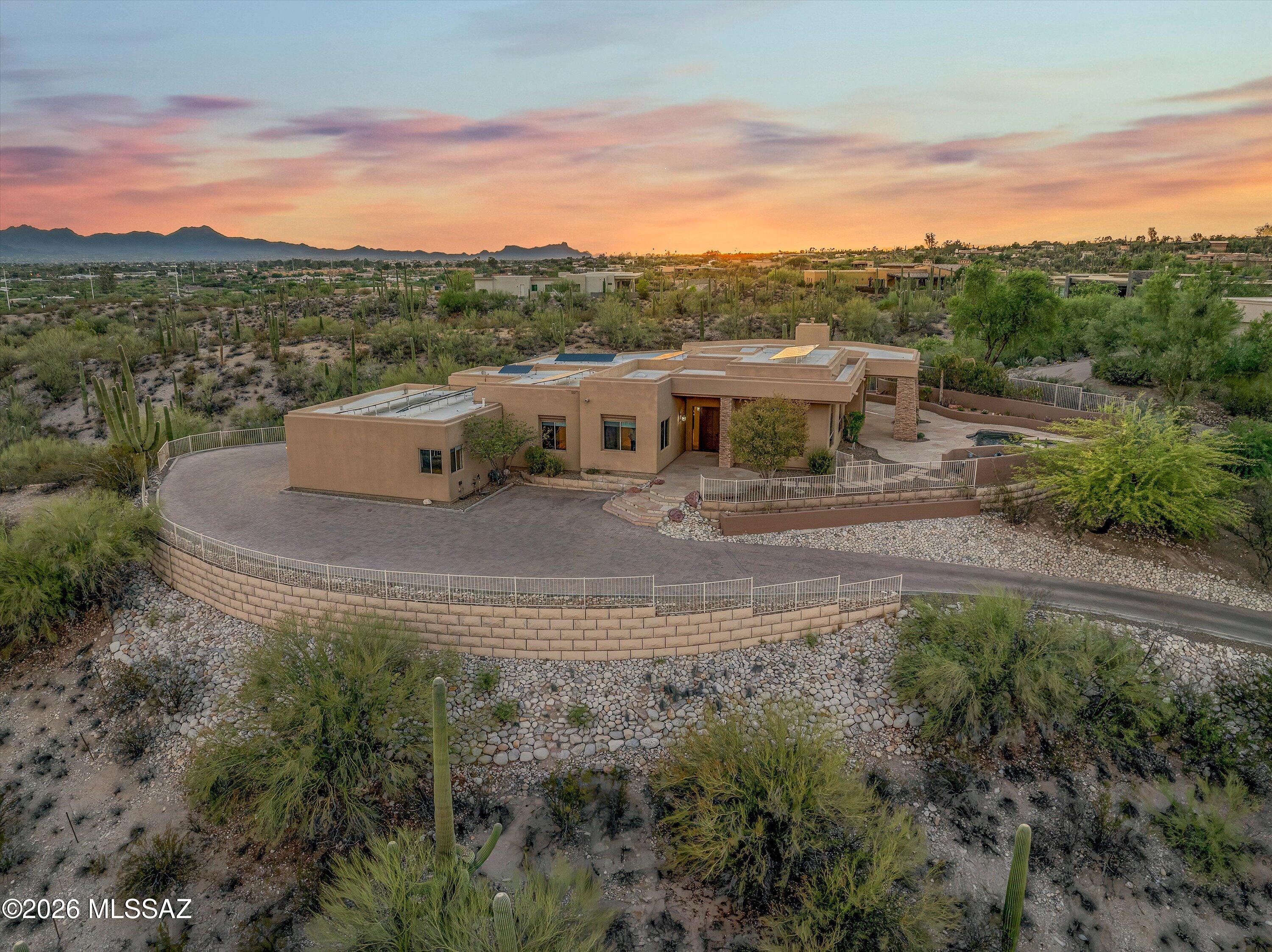 Wake up to mountain views. End the day with sparkling city lights. Set on a premier 1.5-acre lot in Bellas Catalinas Estates, this foothills home offers panoramic views of the Catalina Mountains, the Tucson skyline, and the surrounding Sonoran Desert from nearly every window. The updated kitchen features a spacious walk-in pantry and opens to inviting living spaces, including a stunning living room and library with expansive windows that frame the Catalina Mountains like artwork. The oversized primary suite is a private retreat with multiple windows overlooking the city and a hillside dotted with towering saguaros, along with a large walk-in closet. Outside, the beautifully landscaped backyard offers the perfect place to relax, entertain, and enjoy Tucson's unforgettable sunsets. This is Tucson foothills living at its best, offering the privacy, views, and connection to the desert landscape that make this area so special.