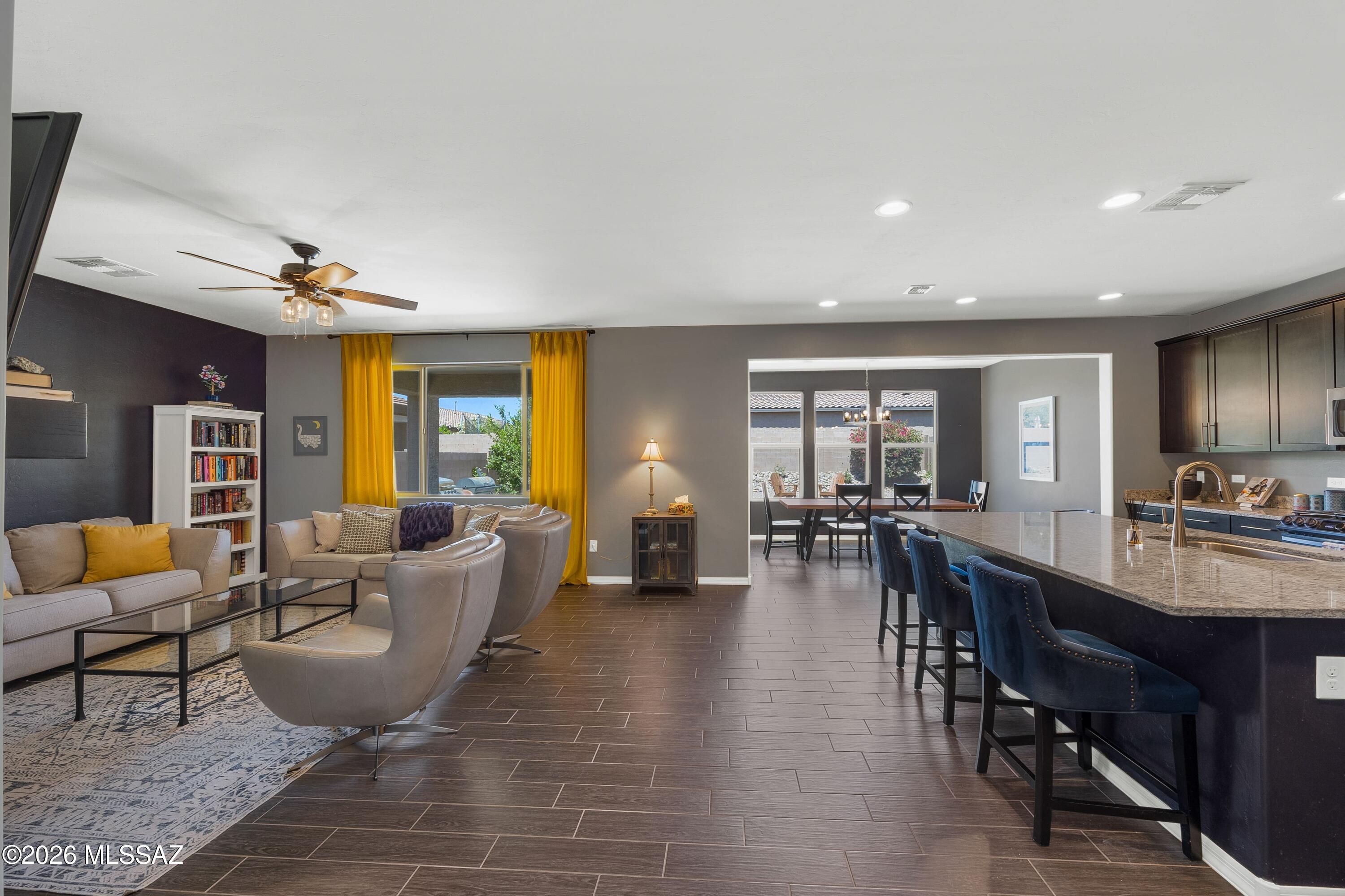 This charming two-story home is designed for everyday comfort. Upon entry, you're welcomed by a foyer with a versatile office/den/library and a convenient half bath. The space opens into an inviting family room with a fireplace that flows seamlessly into the spacious kitchen, perfect for hosting gatherings, holidays, and everyday moments. The kitchen features ample counter space, a large pantry, and an expanded dining area to accommodate additional seating. Just off the garage entry, a thoughtfully designed drop zone provides the perfect place for shoes, bags, and daily essentials. Upstairs, you'll find two secondary bedrooms with walk-in closets, a spacious primary suite, and a flexible loft area ideal for a game room, homework station, or additional lounge space. The north-facing backyard offers a sense of privacy, complemented by mature landscaping and mountain views. Additional highlights include a two-car garage and a tucked-away neighborhood setting that feels peaceful yet conveniently located. A perfect home with space to grow, gather, and enjoy.