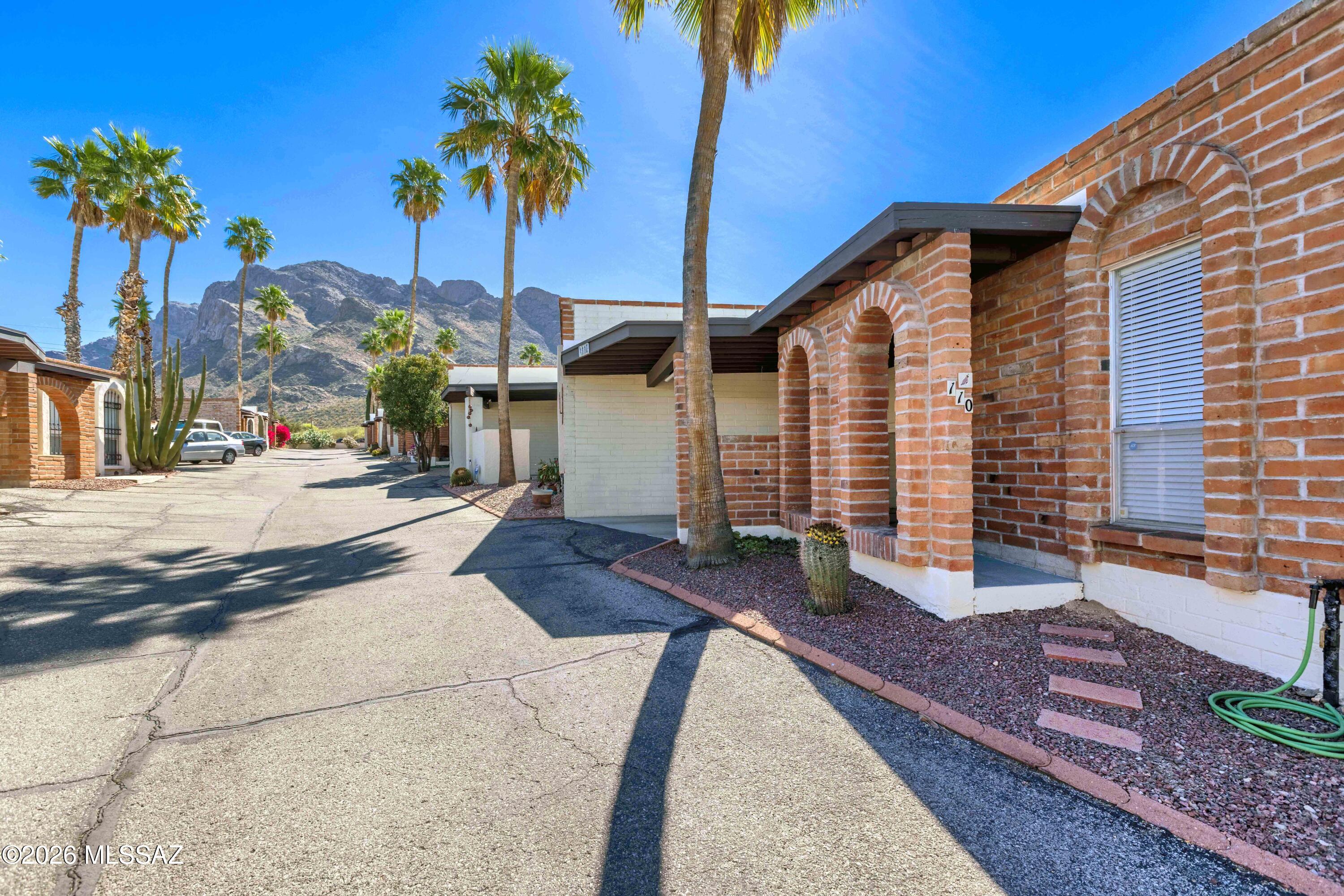Tucked away at the quiet end of this cozy community of townhomes in Oro Valley, you will find this 2 bed / 2 bath Treasure. The location makes this one THE ONE. The shaded back patio yard is a private Oasis, complete with a gardening shed, where you can enjoy the hummingbirds, mature grapefruit tree, and flowers while sipping your favorite morning or evening beverage. The kitchen is updated with beautiful cabinets and butcher block counters; bathroom vanities with the same. The open living space features a beehive style wood burning fireplace, and the home has tile & wood vinyl plank throughout, no carpet. The community pool for your enjoyment is just around the corner. This unit has been meticulously maintained and awaits its new owner. Welcome Home!