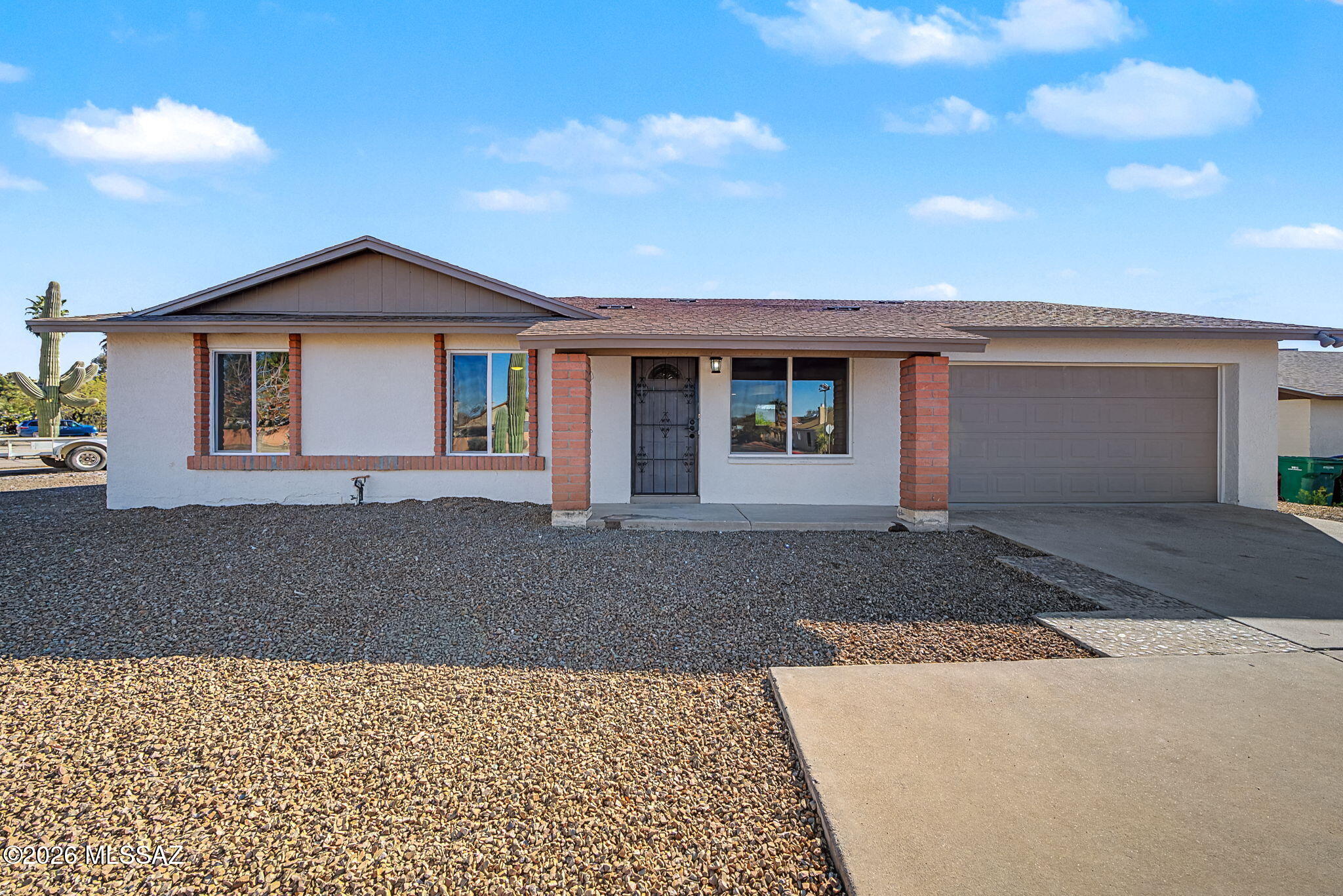 Beautifully updated 3BR/2BA home with 1,513 sq ft on a .24-acre lot in desirable Northwest Tucson. This move-in-ready property features all-new double-pane vinyl windows, recessed lighting throughout, new ceiling fans in every room, and a fully remodeled kitchen with new cabinets, quartz countertops, and stainless steel appliances. The family room sits off the kitchen and includes a cozy fireplace. The spacious primary suite offers a tiled shower and new tile flooring, while the hall bath has been updated with new tile and vanity. Enjoy a private backyard with a restored sparkling pool and covered patio. Polybutylene plumbing replaced. Newer  Roof. 2-car garage and storage room included.