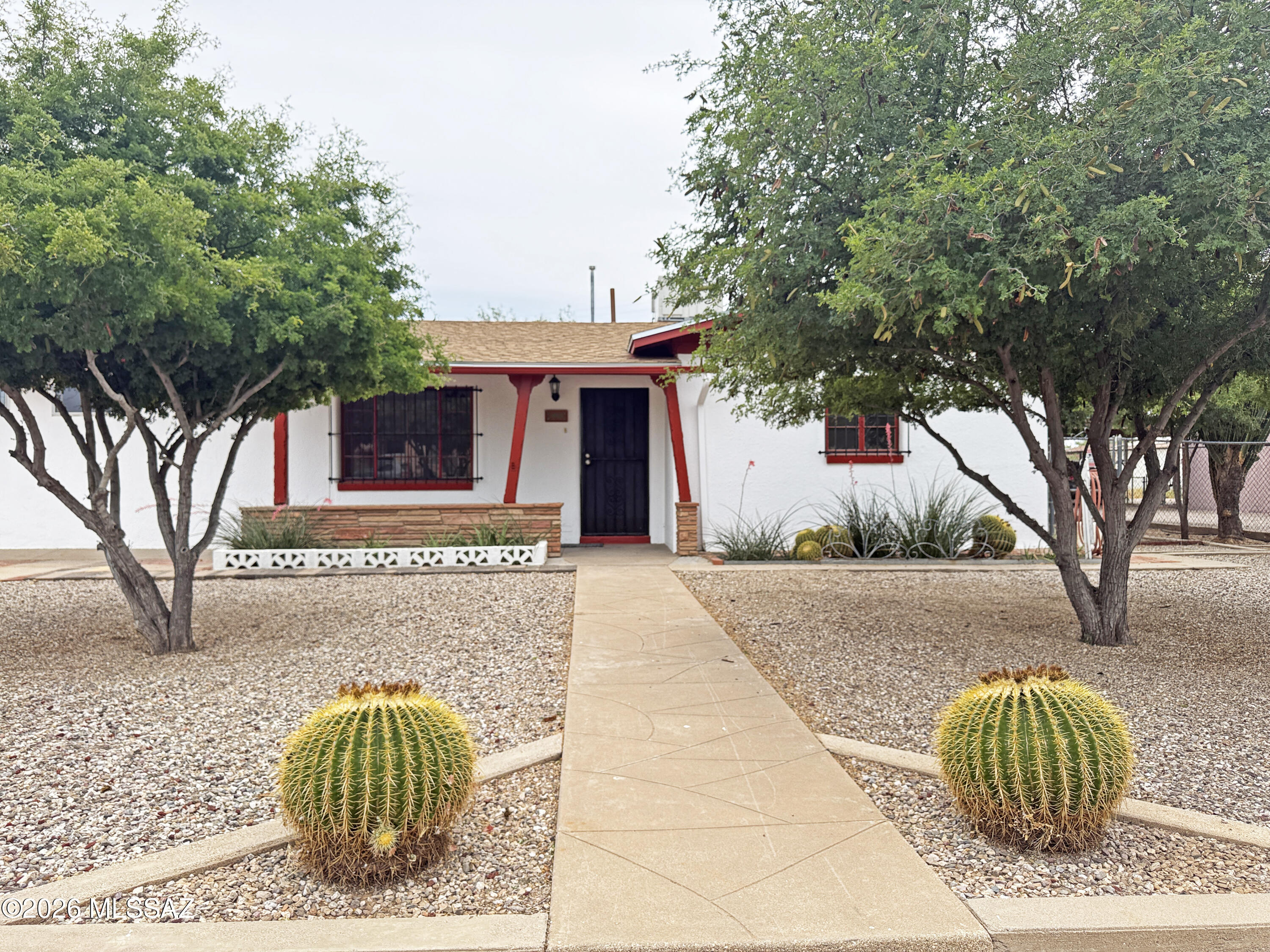 Move-In Ready with Expansion Potential! Home features ceramic tile throughout and fresh interior & exterior paint.    Major improvements include a new roof with warranty and whole-house replumb with Perma-Coat (30-year warranty) for added peace of mind. Situated on a large R-2 lot, offering excellent potential for an ADU or pool. Inside enjoy the fireplace in a large living room with beautiful coved textured ceiling.  2 bedrooms with walk-in closets plus a versatile bonus room with a separate wall A/C -perfect as a 3rd bedroom, office, gym, or media space. Brand-new bathroom by ReBath.
Laundry room offers potential for a second bathroom conversion. Spacious kitchen includes area for eat-in dining and gas stove hookup.  Close to U of A, Banner University Medical Center, shopping & Cat Tran A/C has been refurbished with all new components.
2 sheds in backyard (in much better condition than they look).
