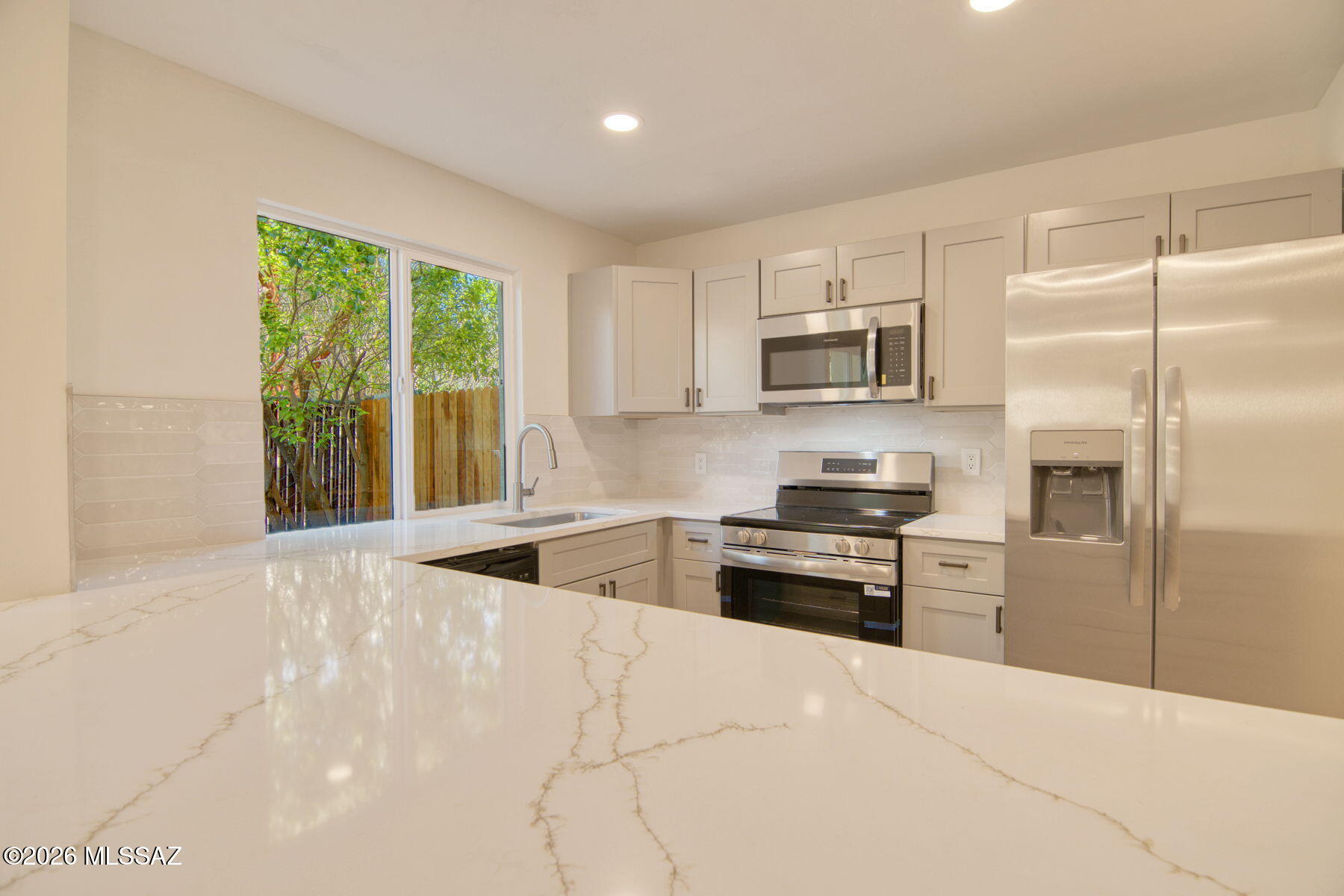 Gorgeous remodeled home in central Tucson just waiting for a new owner. This home has been lovingly restored to ''better than new'' condition. This home has features of homes in much higher price ranges. New kitchen with open concept with all new stainless steel appliances, granite counter tops and all new flooring. The home is equipped with ''paid off, owned solar''. A huge bonus for the buyer. New energy efficient windows, fresh paint, new carpet and all new bathrooms. This home shouts perfection and attention to detail throughout. Don't miss this one.