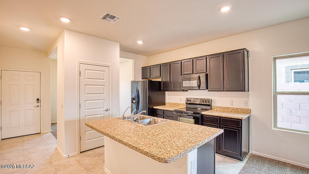 Welcome to this stunning 1260 SF gem featuring 3 bedrooms, 2 full baths, and fantastic curb appeal with a 2-car garage. Inside, you'll love the airy, neutral palette that connects the cozy living area to the formal dining room. The chef-ready kitchen boasts an island with a breakfast bar, a walk-in pantry, and plenty of storage. Retreat to spacious bedrooms with ample closet space, or head outside to your backyard oasis complete with a covered patio, extended seating, and low-maintenance turf. Perfect for entertaining!