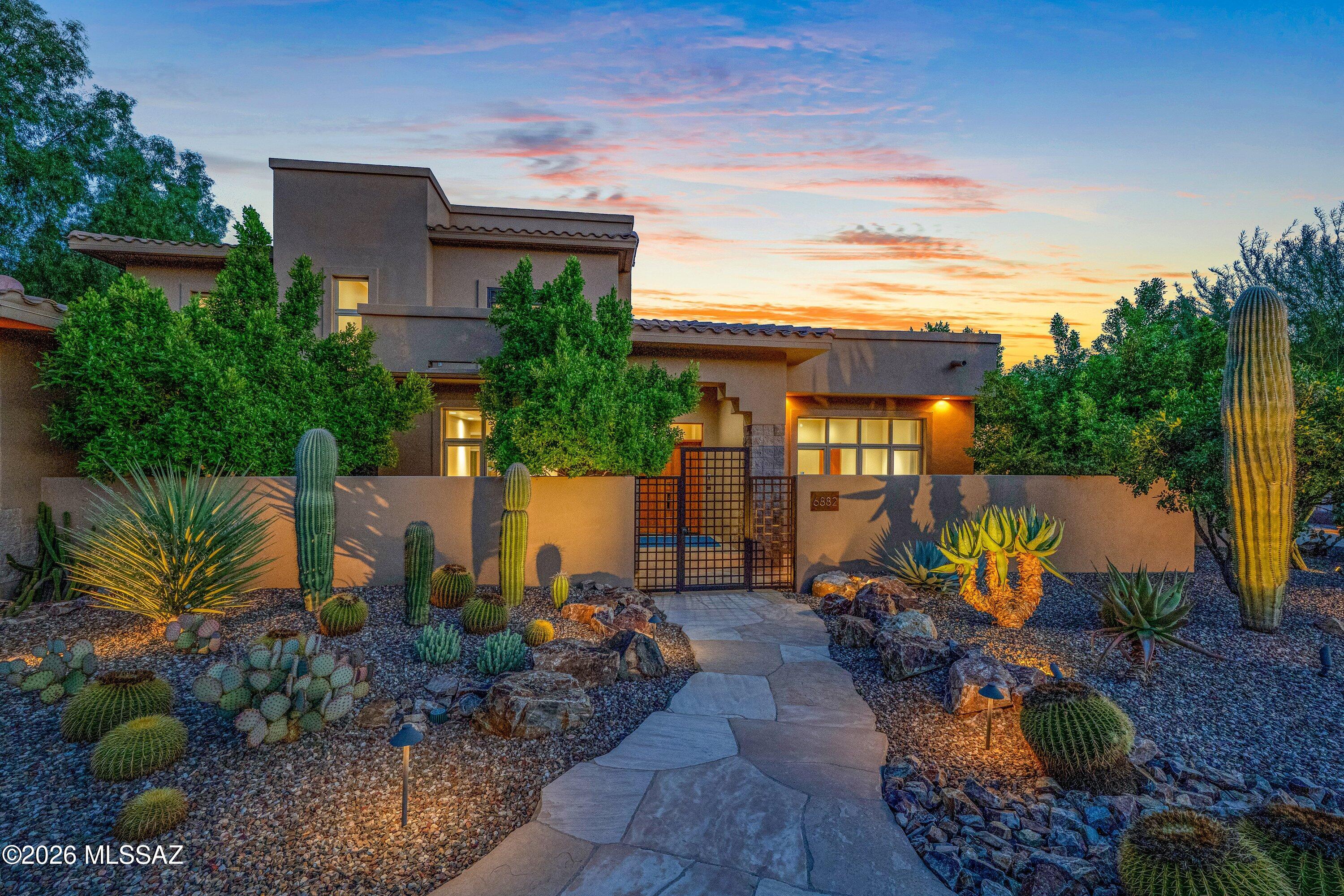 Live the Tucson lifestyle from this exceptional home in gated Ventana Canyon Country Club Estates. Tucked into a quiet cul-de-sac with Catalina Mountain views, this spacious 5-bedroom, 4-bath residence with office/den offers nearly 5,000 sq. ft. with a flexible floor plan, generous living spaces and wonderful indoor-outdoor living.

A flagstone courtyard surrounded by mature desert landscaping creates a beautiful sense of arrival. Inside, high ceilings and expansive windows bring in natural light, while multiple living and dining areas provide plenty of room to gather, entertain or simply enjoy the surroundings. The kitchen opens to the family room and breakfast area with easy access to the covered patio and backyard. The primary suite is conveniently located on the main level and opens to a private patio. A second downstairs bedroom and office/den add flexibility for guests or working from home. Upstairs, three additional bedrooms, a full bath and loft/family room provide a separate living area, with French doors opening to a north-facing balcony and Catalina Mountain views.

The backyard is a standout feature of the property. Designed by renowned landscape architect John Stropko of New Desert Gallery, the grounds combine mature desert landscaping, custom stonework, flagstone patios and pathways, and a variety of inviting places to sit and enjoy the setting. An expansive covered patio, Pebble-Tec pool and spa, and built-in outdoor kitchen make this a home designed to take full advantage of Tucson's year-round outdoor lifestyle.

Additional features include an oversized 3-car garage, a large heated and cooled bonus room, walk-in pantry and abundant storage. Close to Sabino Canyon, hiking and biking trails, shopping, dining and District 16 schools. Ventana Canyon Country Club golf, racquet and social memberships are available separately. A wonderful opportunity to enjoy space, privacy, mountain views and the Ventana Canyon lifestyle.