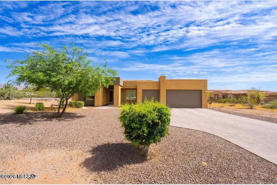 Former Model Home in the Tanque Verde Valley! This 2,894 sq. ft. residence offers 4 bedrooms, 2.5 baths, an upgraded powder room with floor-to-ceiling tile, and a versatile flex room. The layout features soaring ceilings, granite countertops, stainless steel appliances, upgraded flooring, and Hunter Douglas motorized shades.  A landscaped backyard with covered patio and spectacular mountain views, the perfect backdrop for Arizona sunsets. Rarely does a home of this caliber, quality, and location become available in one of Tucson's most desirable communities. KitchenAid stainless steel refrigerator included. subject to lender guidelines).