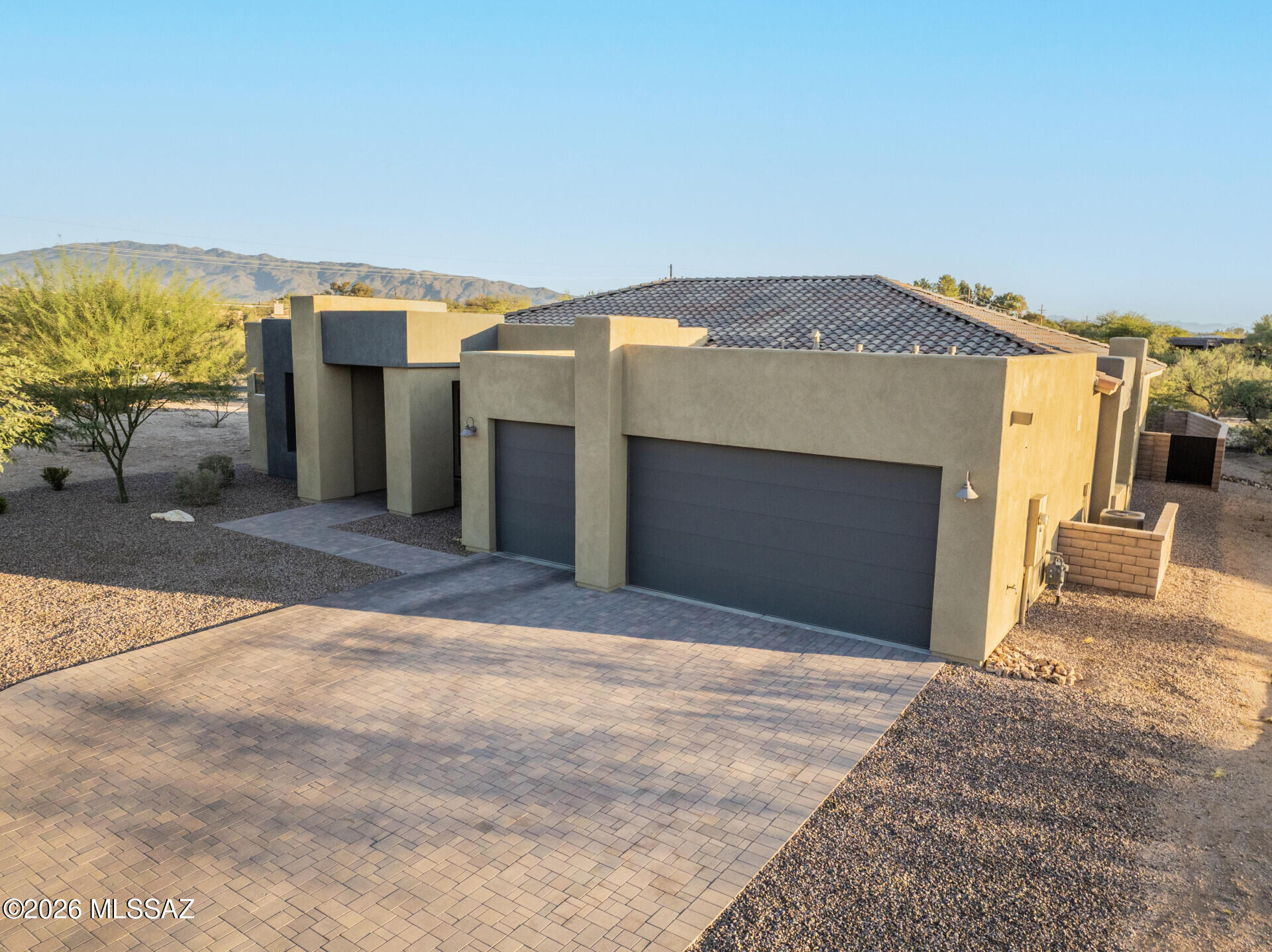 Former Model Home in the Tanque Verde Valley! This 2,894 sq. ft. residence offers 4 bedrooms, 2.5 baths, an upgraded powder room with floor-to-ceiling tile, and a versatile flex room. The layout features soaring ceilings, granite countertops, stainless steel appliances, upgraded flooring, and Hunter Douglas motorized shades.  A landscaped backyard with covered patio and spectacular mountain views, the perfect backdrop for Arizona sunsets. Rarely does a home of this caliber, quality, and location become available in one of Tucson's most desirable communities. KitchenAid stainless steel refrigerator included.