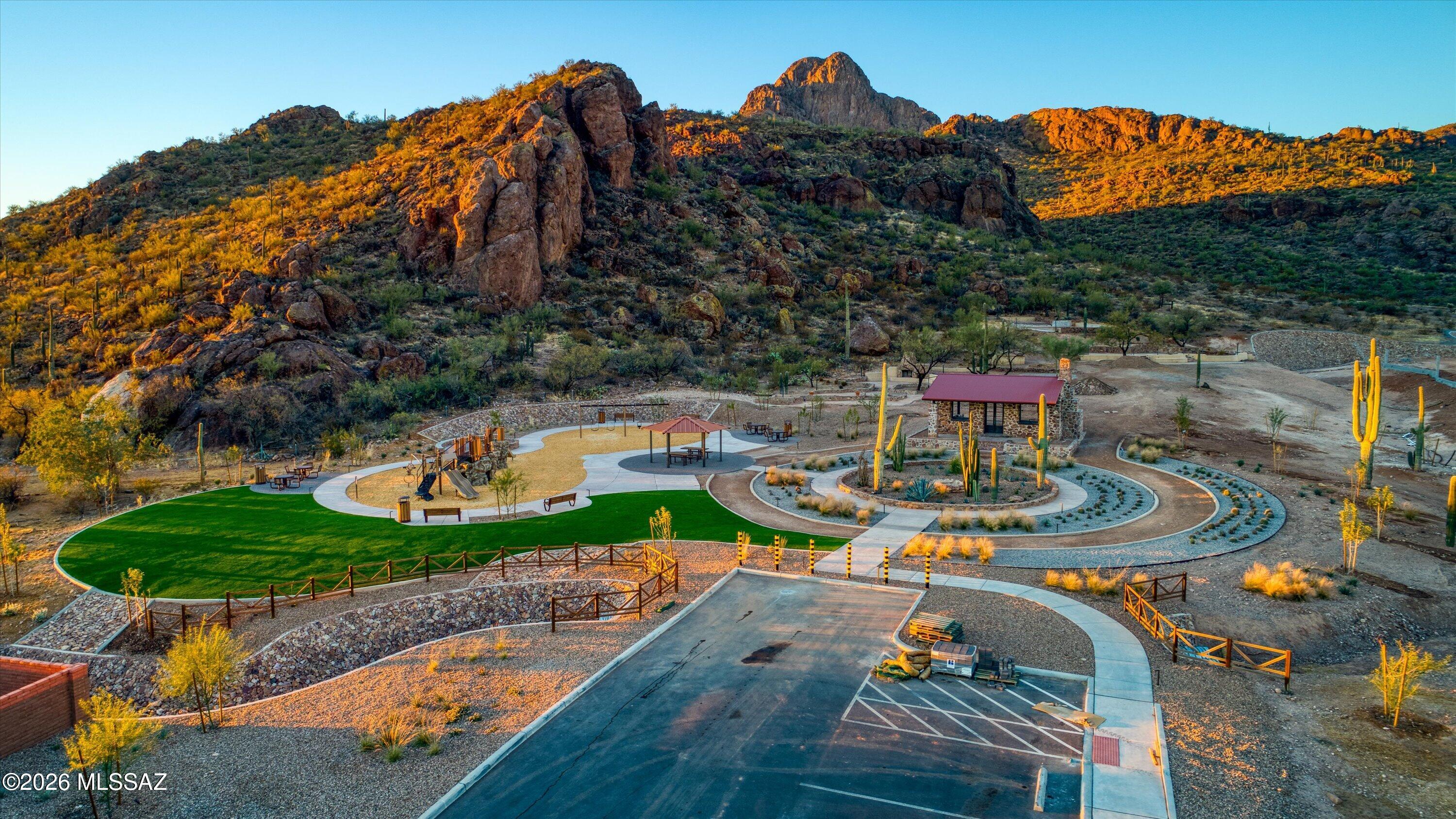 AFFORDABLE OPPORTUNITY TO BUY NOW! Take advantage of a $10K seller credit with an acceptable offer PLUS a lender-paid incentive that may reduce your interest rate by up to 1% for the 1st year! Unlike starting from scratch with new construction, this immaculate 2021-built home is already upgraded, fully landscaped & move-in ready with 24x48 tile throughout, upgraded baseboards, courtyard & backyard water features, decorative wrought-iron courtyard security door, 9motorized blinds, gutters & so much more! With 4BR/4BA & 2 private ensuites, this home is ideal for guests or multigenerational living. A gourmet kitchen, extraordinary walk-in pantry & generous entertaining spaces flow effortlessly into the outdoor living areas, where the breathtaking desert & mountain backdrop takes center stage! Bordering Saguaro National Park, you're not simply purchasing a home--you're investing in a lifestyle defined by privacy, protected views, and the iconic beauty of Southern Arizona.  All within reach of Tucson's conveniences, yet worlds away from congestion.