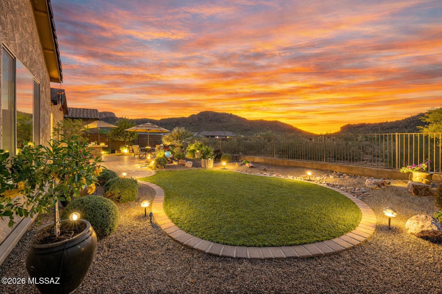 Imagine waking up to uninterrupted mountain views, hot air balloons floating against a Sonoran Desert sunrise, & the peaceful stillness that only a home backing to protected land can provide. Located in the gated, historic enclave of Lazy K Bar Ranch, this property offers the privacy & lifestyle today's relocation buyers are seeking -- space, serenity, and meaningful connection to nature. For executives, remote professionals, & multigenerational households relocating from higher-density markets, this 3,557 sq. ft. residence delivers flexibility & comfort with two private ensuites, expansive entertaining areas, & seamless indoor-outdoor living. The gourmet kitchen & extraordinary walk-in pantry elevate daily living, while the landscaped backyard with built-in barbecue & sunset terrace transforms evenings into experiences.
Bordering Saguaro National Park, you're not simply purchasing a home -- you're investing in a lifestyle defined by privacy, protected views, and the iconic beauty of Southern Arizona. All within reach of Tucson's conveniences, yet worlds away from congestion.