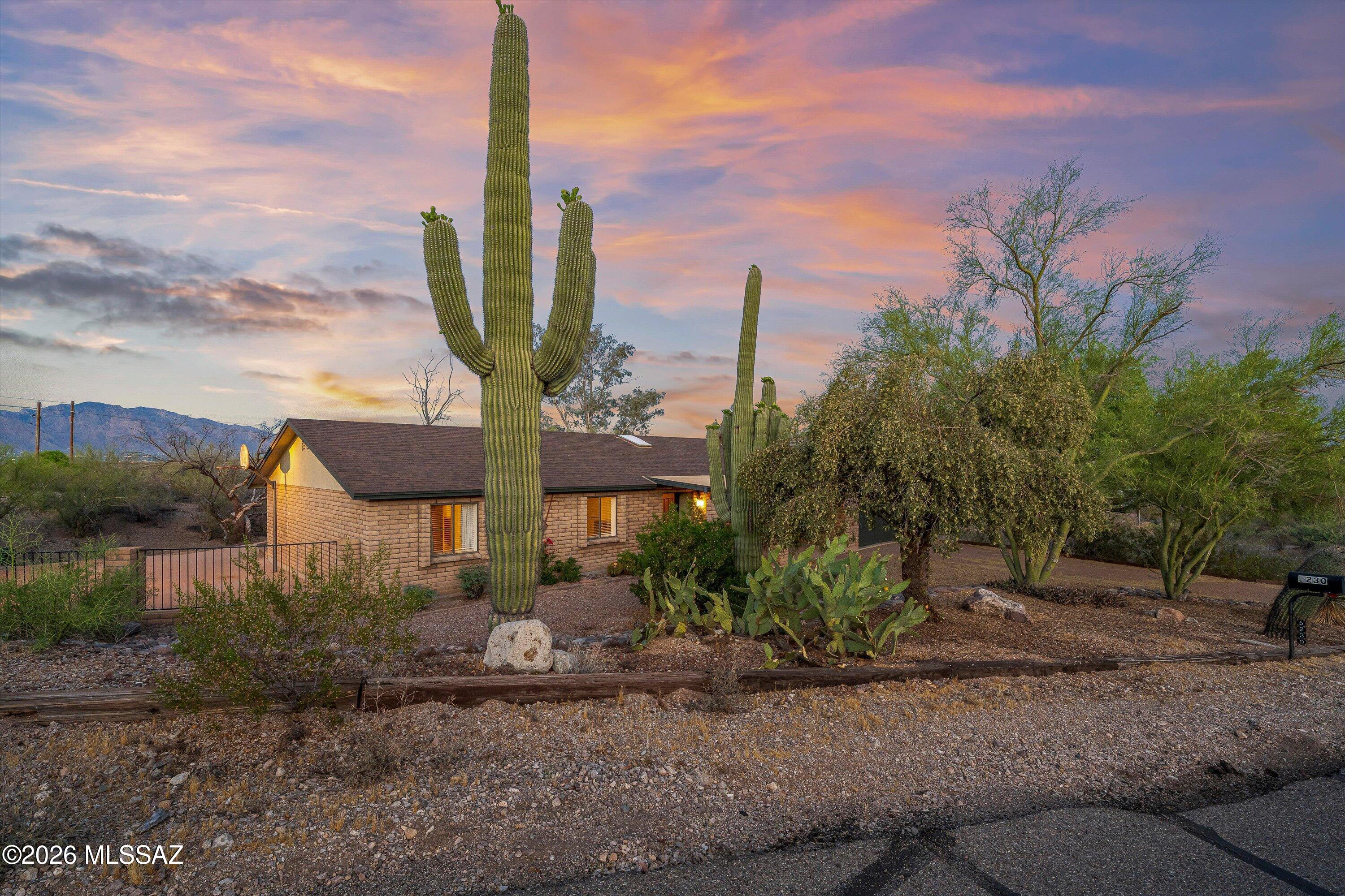 Refined, private, and distinctly elevated, this exceptional 3-bedroom, 2-bath ranch-style estate embodies the essence of Sonoran Desert luxury living. Set on over two acres within the coveted Del Cerro Estates enclave in Tucson, this 1,844-square-foot residence offers a rare fusion of refined comfort, natural beauty, and premier equestrian potential. Framed by sweeping Tucson Mountain vistas and surrounded by lush riparian habitat, the property delivers a setting of remarkable serenity--where desert wildlife, open skies, and panoramic views create an atmosphere of quiet sophistication. A gracious covered front porch welcomes you into an elegant interior, where formal living and dining spaces are thoughtfully designed for both upscale entertaining and intimate gatherings. Recent enhancement provide both style and substance, including a new roof and exterior paint (2023), a new hot water heater (2024), an owner-owned reverse osmosis system, and the added confidence of no poly piping. The heart of the home is a warm and inviting family room, anchored by a charming gas fireplace and framed by expansive windows that showcase the ever-changing desert landscape as a living work of art. Outdoors, the estate truly distinguishes itself. Zoned for horse property, the expansive grounds offer exceptional potential for a custom equestrian setup, whether envisioning stables, corals, riding arenas, or direct access to nearby trails. The acreage also provides ample room for a guest house or ADU, allowing for a multi-generational compound or private retreat. The covered rear patio serves as a tranquil vantage point for sunrise mornings and golden desert evenings, seamlessly blending indoors and outdoor living. Additional features including extra storage, a shipping container, and a playground gym offer flexibility while preserving the estate's refined character and functional versatility. Ideally situated just minutes from I-10, downtown Tucson, and the University of Arizona, the property offers the rare balance of secluded desert living with effortless access to the city's premier amenities. This is more than a home, it is a private desert estate designed for those who value space, serenity, and the elevated equestrian lifestyle. No HOA, come bring your toys and see this property for yourself, today!