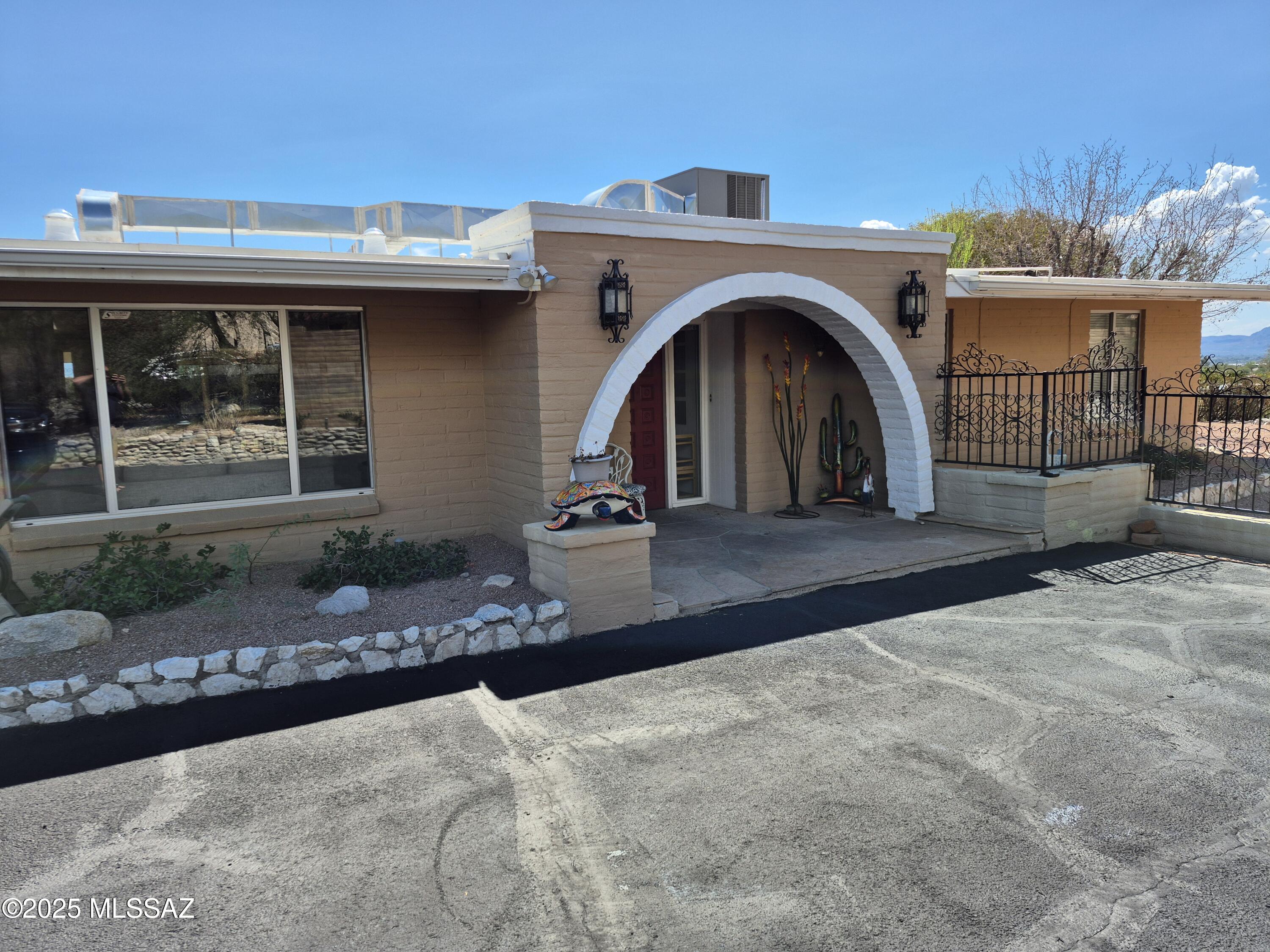 Enjoy panoramic city views throughout the open floorplan of this hilltop lot. The large great room welcomes you into the home and you immediately feel at ease amongst the oversized comfortable sitting areas. The kitchen features granite countertops and is equipped with all you need to create a gourmet meal. Boasting a split floorplan with two master suites, 2 additional bedrooms, and office; the home can be set up to meet a variety of tenant needs. The backyard is low maintenance with artificial turf, covered patios, and amazing views of the Tucson Valley. The home is offered fully furnished & is available for 3 month or longer rentals.  Tenant pays utilities, unless negotiated into the rate. Driveway has parking for 4-6 cars(garage not included in rental). Contact JC for more information