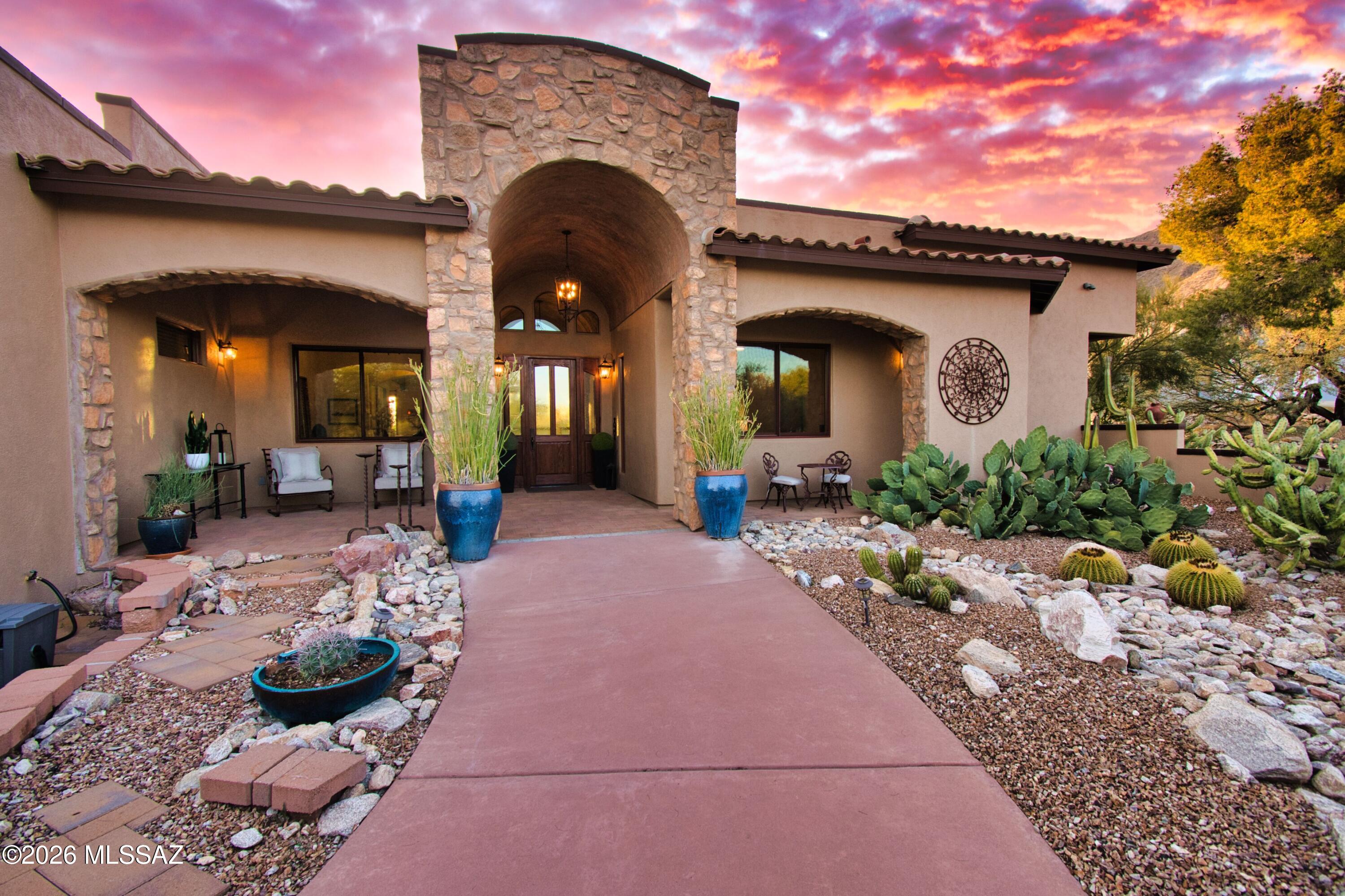 This Santa Barbara inspired 4 BR, 3BA estate at the Catalina Foothills built in 2010 and blends  timeless architecture with refined modern luxury. The Mediterranean aesthetic blends Old World charm with a circular colored concrete and belgard paved driveway, entry courtyard, red deep tiled patios, arched doorways,
and stacked stone details designed to create unified, picturesque, and romantic atmosphere. Dramatic 8'' custom cedar entry door, Vatican Botticelli porcelain floors, exposed beans, arched hallways, and custom built-ins, highlight the expansive light filled living spaces and the elegant chef's kitchen overlooking the great rm. The expansive primary suite boasts resort style bath with a luxurious oversized shower, jetted tub, his and her vanity and an oversized closet with custom shelving. A resort style yard showcases a sparkling negative edge saltwater pool. Built-in Barbeque and professional lush desert landscaping. Ideally located in the heart of Skyline Country Club, moments from premier dining, golf, tennis, hiking trails, shopping and direct access to the scenic golf course. This residence offers an exceptional blend of charm, sophistication, lifestyle and privacy.