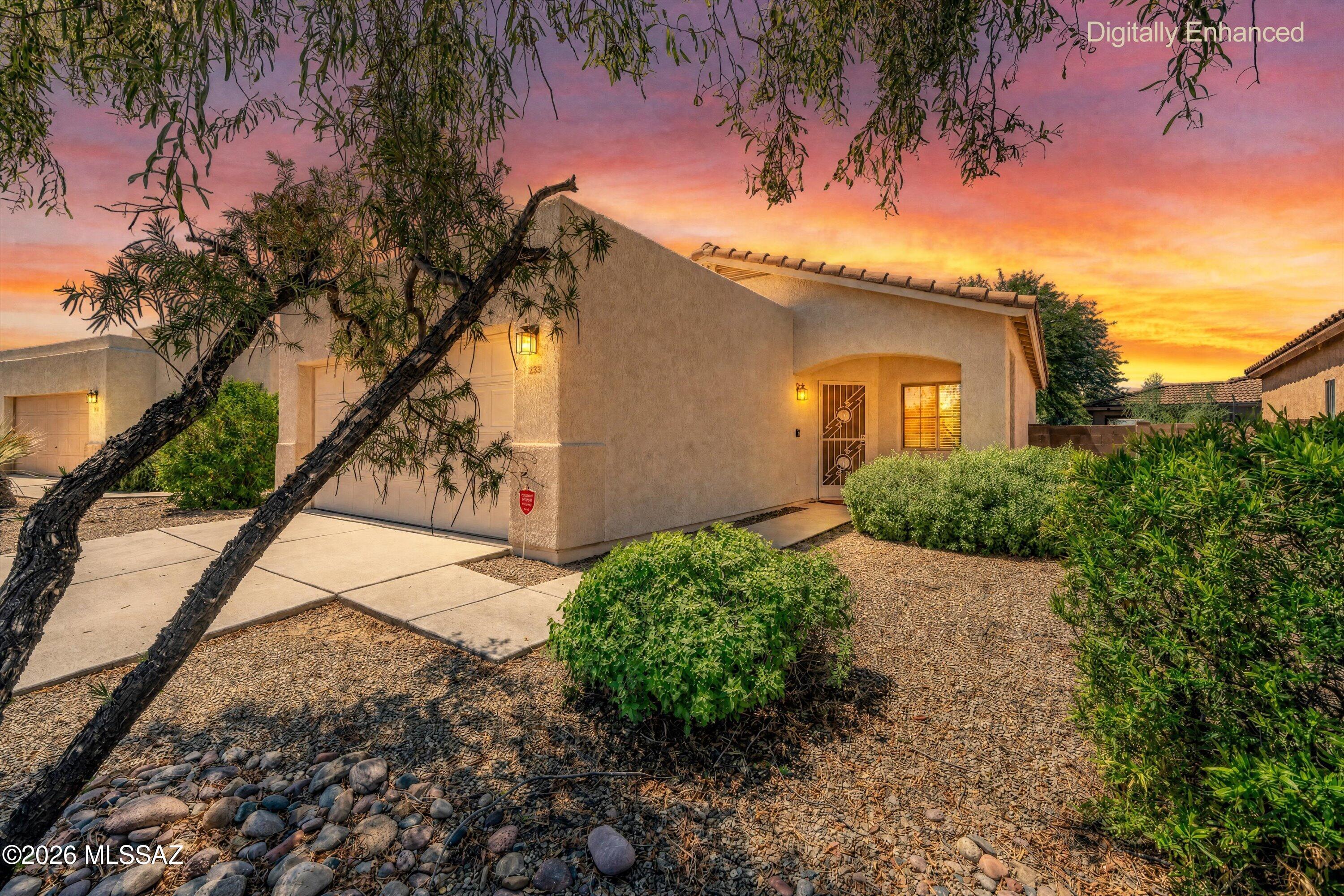 Located in North Tucson's Riverside Crossing, this 1,028-square-foot home features a huge, peaceful low care yard with a single-story, split-bedroom floor plan. Ceramic tile flooring and plantation shutters are throughout the living space, complete with a built-in entertainment center. The kitchen includes an eat in breakfast bar open to the rest of the bright, airy great room. In the primary suite, find a full bath and large walk-in closet. Outdoor living expands onto a large paver patio, surrounded by a  private block-walled yard with low-care desert landscaping. Highlights include a two-car garage, wrought iron security doors, a tile roof, and HOA-maintained front grounds with community pool access.