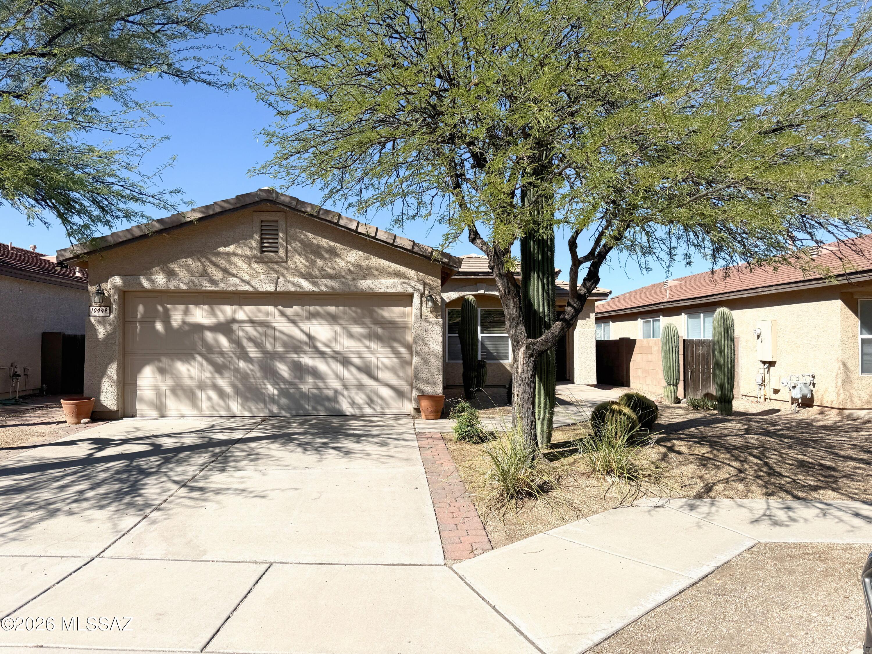 No Application Fees! Beautiful single level 3 bedroom plus den, 2 bathroom Tucson home located in the Mesquite Ranch community offering an open floor plan and stunning mountain views. This home features laminate flooring throughout the main living areas with carpeting in the bedrooms, warm two-tone neutral paint, upgraded 2-inch wood window blinds, and ceiling fans in each room. The spacious living room flows into the upgraded kitchen which includes extended countertop space, island with breakfast bar, separate dining area, electric range, built in microwave, dishwasher, and refrigerator. The oversized primary suite offers backyard views, two closets, and a private bathroom with dual sink vanity and step in shower. The versatile den provides additional space for a home office, game room, or guest area. Washing machine and dryer are included along with an additional freezer, and the two-car garage provides ample parking and storage. The backyard is designed for relaxation and entertaining with a covered patio, extended paver patio, elevated pergola covered sitting area, synthetic grass, easy to maintain desert landscaping, and beautiful mountain views.

Mesquite Ranch is a well established East Tucson community offering nearby parks, walking paths, and convenient access to schools, shopping, and dining. The location near Houghton Road and Drexel Road provides easy connectivity to I10 and Davis Monthan Air Force Base while maintaining a quiet residential neighborhood environment with surrounding mountain views.

All Denali Real Estate residents are automatically enrolled in the Resident Benefits Package (RBP) for $55.00/month which includes Renter's Liability Insurance, Credit Building to help boost the resident's credit scores with timely rent payments, up to $1M Identity Theft Protection, HVAC air filter delivery (for applicable properties), our best-in-class resident rewards program, and much more!
