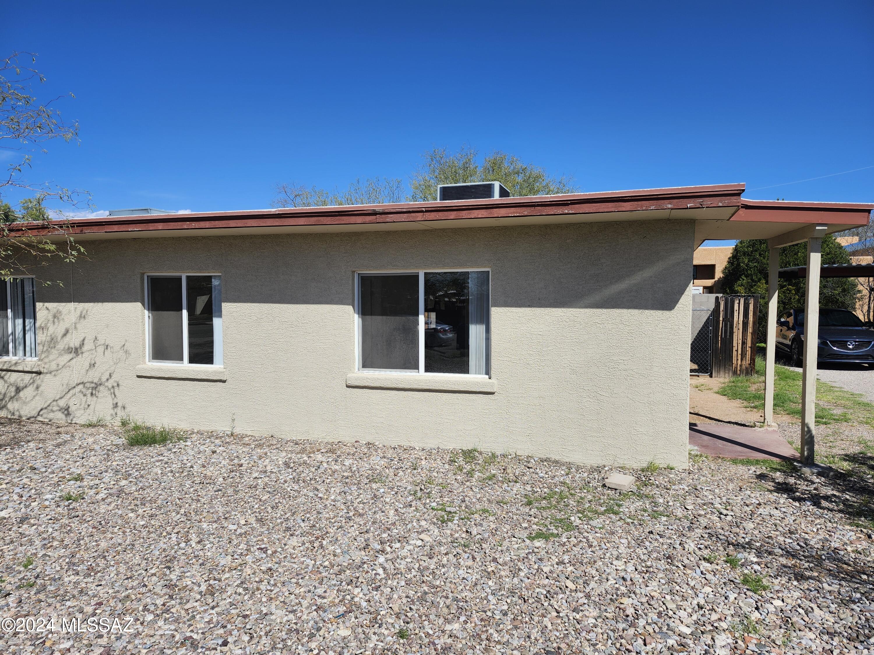 Beautiful duplex in Central Tucson featuring 2 bedrooms and 1 bathroom. This lovely layout embraces a great room design with tile flooring throughout. Enjoy the convenience of a well-appointed kitchen with updated countertops, cabinets, and all appliances. Stay comfortable year-round with central A/C, heating and ceiling fans. Outside, a large fenced yard with covered patio, offers privacy and space. Private parking adds to the convenience, and the location is close to bus lines, shopping centers, and hospitals.''