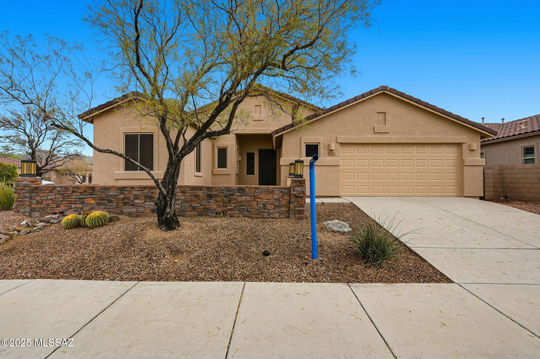 New exciting price! ''Motivated Seller'' This 1,955 sq ft house has been freshly painted on the exterior. It has three bedrooms, two full baths, and an open floor plan in a gate community. Beautiful tiled floors, custom palette, upgraded lighting, plant shelves, unique crown molding, window blinds, ceiling fans, & French patio door. Center kitchen island, granite counters, breakfast bar, stainless steel appliances, tiled backsplash, pantry & honey maple cabinetry, tumbled stone backsplash, custom crown molding, slab granite, decorator paint, plush carpet in all the right places, generous-sized bedrooms, ample closets. Tile surround showers, elegant raised sinks, tiled counters, designer sinks & fixtures. The laundry room has a washer, dryer, storage, and cabinets. Enjoy this .23-acre oversized corner lot, courtyard entry; the backyard has a covered patio, synthetic turf, and exterior fireplace on a paved patio with desert plants, landscaping, an outdoor sitting area, a KIVA fireplace, and wrap banco seating to enjoy mountain views. Gated Community of The Preserve, offering a Community golf course, Rec Center, Tennis, & more. Enjoy Dove Mountain's fantastic desert terrain, including hiking, biking, trails, and restaurants. This is a must-see!