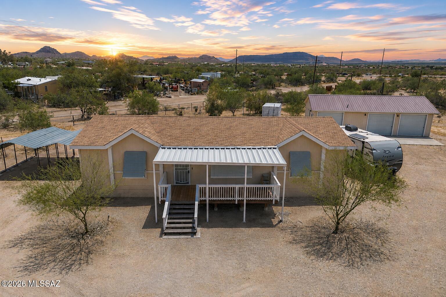 Range Pricing: Seller to counter or accept offers between $274,900 and $299,900.Welcome to a home that offers space, flexibility, and the kind of lifestyle that's getting harder to find. This beautifully maintained, newer manufactured home (less than six years old) features 3 bedrooms and 2 bathrooms, thoughtfully cared for and truly move-in ready. Inside, you'll find a clean, comfortable layout with sun shutters on every window--bringing in natural light while giving you both style and privacy. Every detail has been kept with care, creating a home that feels as good as it looks. Start your mornings or wind down your evenings on the inviting front porch, where you can take in peaceful surroundings and enjoy stunning sunset views over the mountains. This is the kind of setting that makes you slow down and stay a little longer. Set on a fully fenced .83-acre lot with an electric gate; the property offers room to spread out, create, and enjoy. With two carports and a versatile workshop, you'll have space for vehicles, hobbies, storage--or all of the above. The workshop is a standout feature, complete with a half bath and its own mini split system to keep things comfortable year-round, making it the perfect extension of your living space. Whether you're looking for room to breathe, a place to work and create, or simply a home that's been truly cared for, this property delivers. If you've been waiting for space, flexibility, and a property that truly checks the boxes--this is it. Reach out today to schedule your private tour before it's gone.