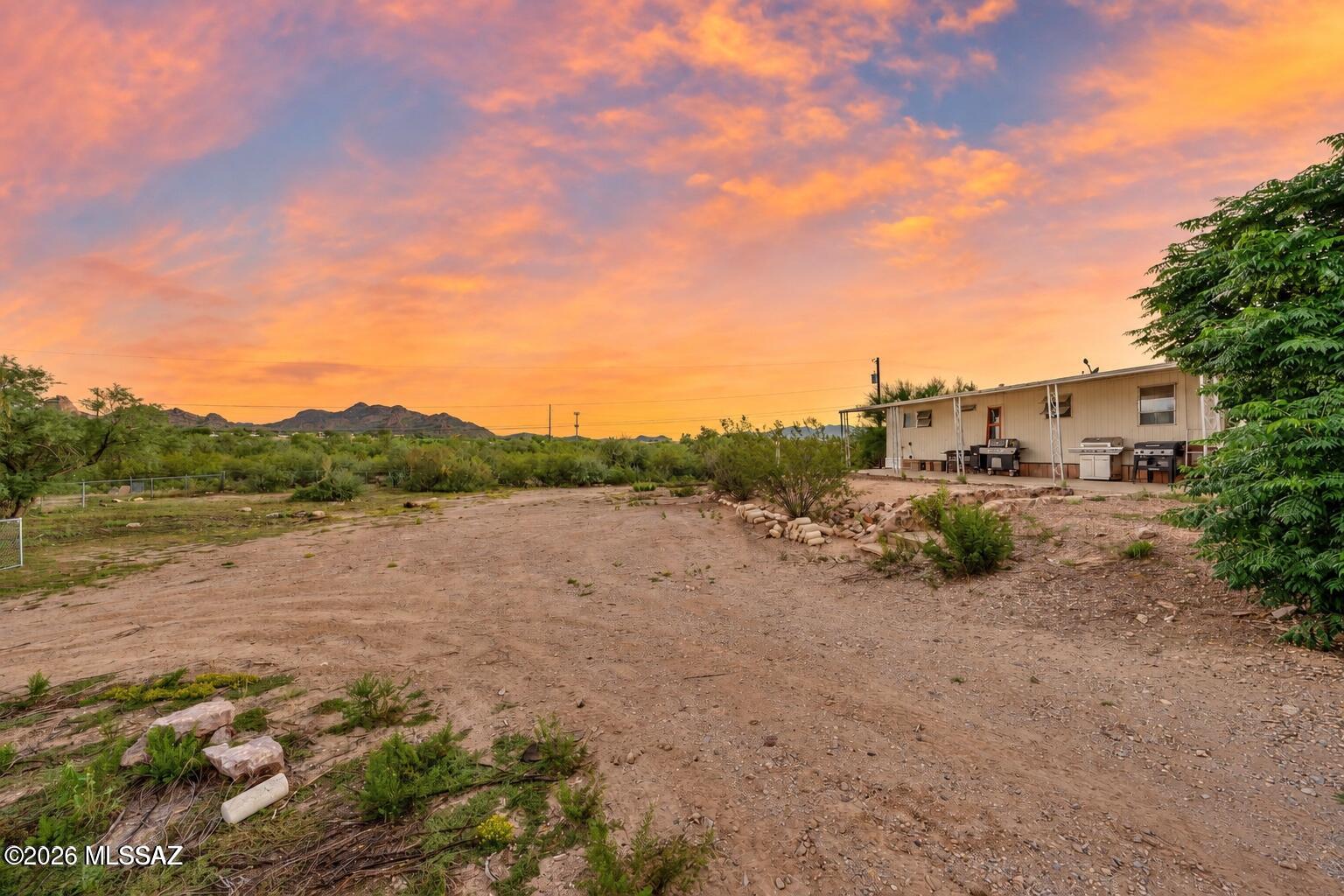 Discover space, privacy, and added potential on this fully fenced, acre-plus property in Southwest Tucson. The manufactured home offers three bedrooms, two bathrooms, and generous living spaces throughout. Vaulted living and family rooms provide plenty of room to gather, while a fireplace adds warmth and character to the family room. The primary suite features a spacious five-piece bath with garden tub, and additional interior features include a built-in buffet, wet bar, bright kitchen, and dedicated laundry room.

Outside, the property offers two covered patios, awnings, patio walls, a curved driveway, storage and outbuildings, plus a separate second unit that offers additional possibilities! With more than an acre of fenced land, there is ample room for parking, storage, outdoor living or other uses. Conveniently located near Valencia Road and Cardinal Avenue with easy access to shopping, schools, I-19, dining, entertainment, and the Southwest Tucson corridor. A unique property with space, flexibility, and plenty of potential. Your next chapter starts here!