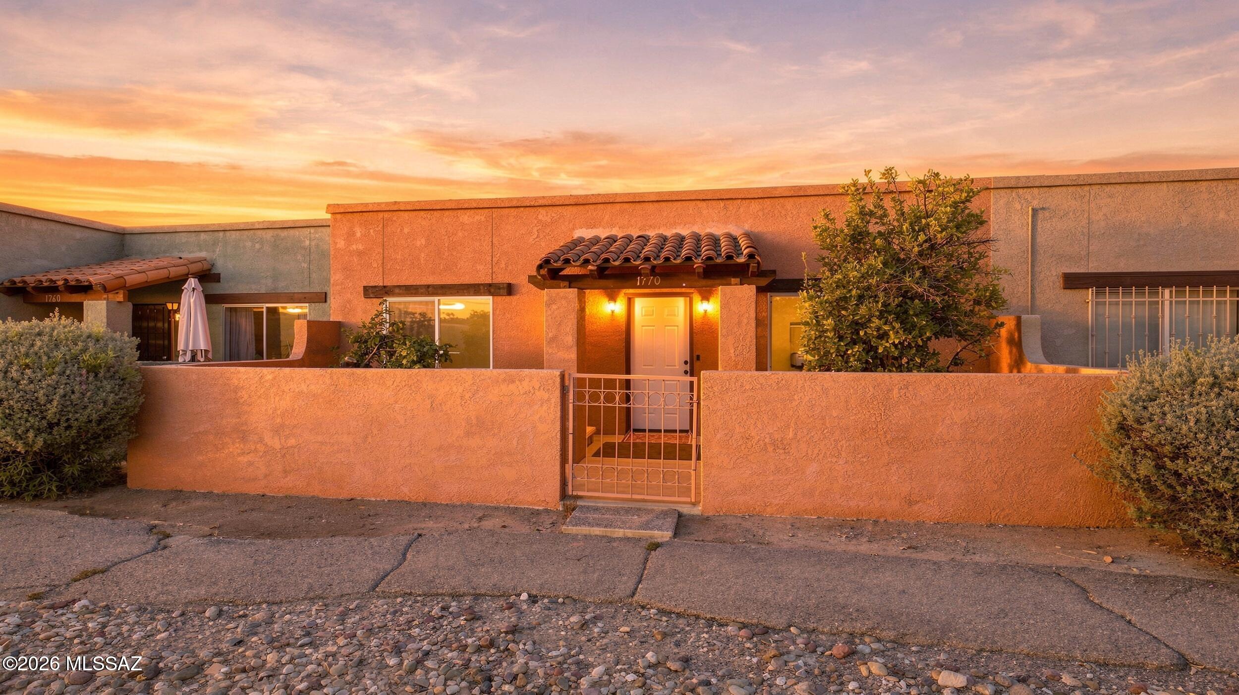 Stunning 2-bedroom, 1-bath townhome situated in the desirable Spanish Meadows! Enjoy a welcoming front courtyard with manicured landscaping. Featuring direct access to the common area, view of the spectacular mountains, convenient access to the visitor parking, and access to the community's heated pool. The lovely, fully updated, turn-key home features newly refinished Saltillo flooring, fresh new interior paint, bountiful natural light from the new double-pane windows, and LED lights throughout. With a fully remodeled bath that like an oasis with upscale tile shower and luxury finishes. The kitchen offers new white shaker cabinetry with updated hardware, new SS appliances, sparkling marble backsplash and gorgeous quartz counters for the chef at home. Outside you'll find a beautifully landscaped rear yard with pavers, z built-in BBQ grill, and plenty of space perfect for relaxing and entertaining. Attached carport includes convenient storage and a private laundry room. Make this beauty your TODAY!