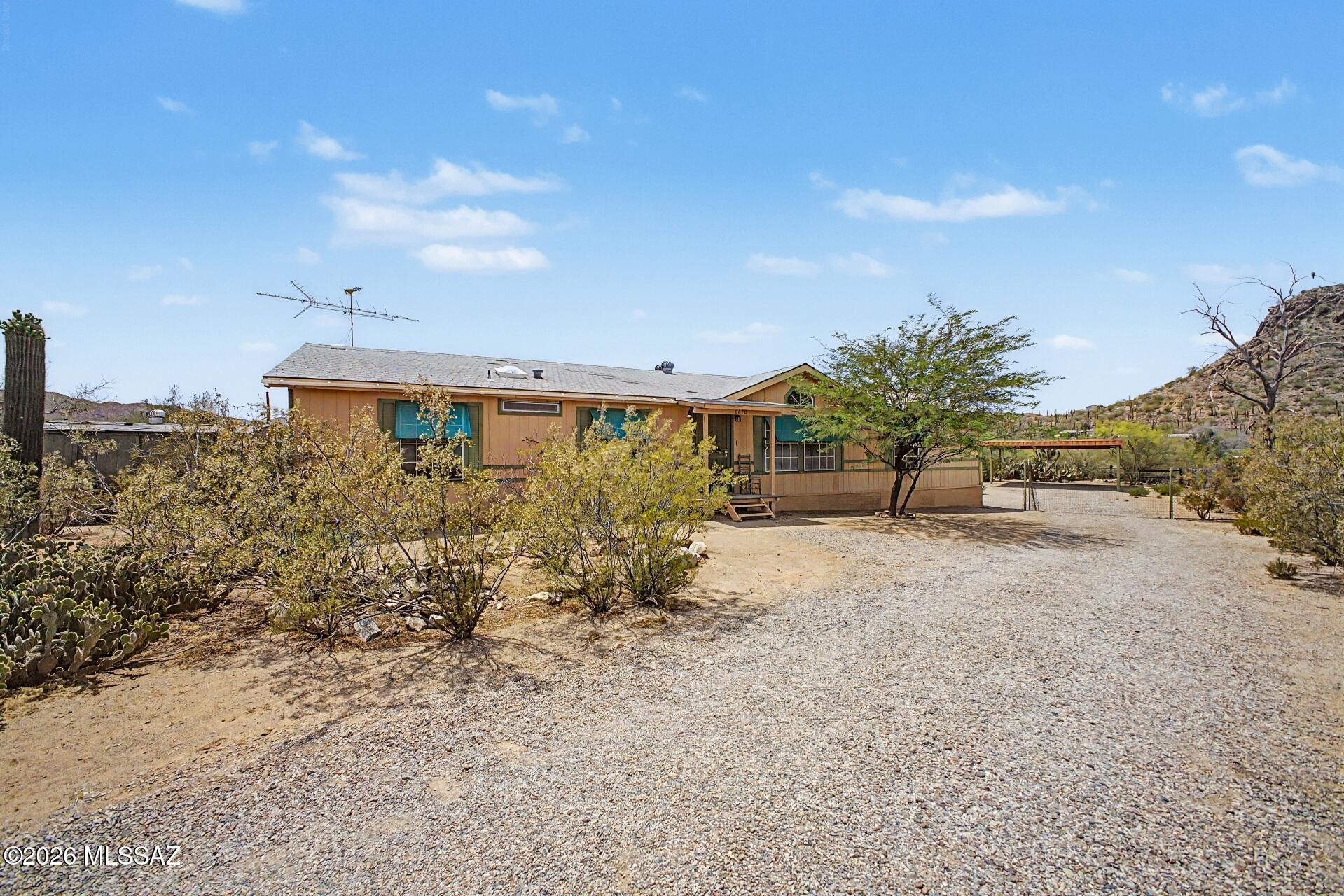 Welcome to this inviting 3-bed, 2-bath gem, featuring 1,904 square feet of potential and charm. While it's already gorgeous, there's plenty of opportunity to put your personal stamp on it. Enjoy the spacious layout, covered parking perfect for all your toys, and no HOA restrictions. Plus, it's just down the road from the stunning Saguaro National Park, offering endless outdoor adventures. And with a brand-new HVAC system installed in April, you'll be comfortable year-round. This private retreat is ready for your next chapter!