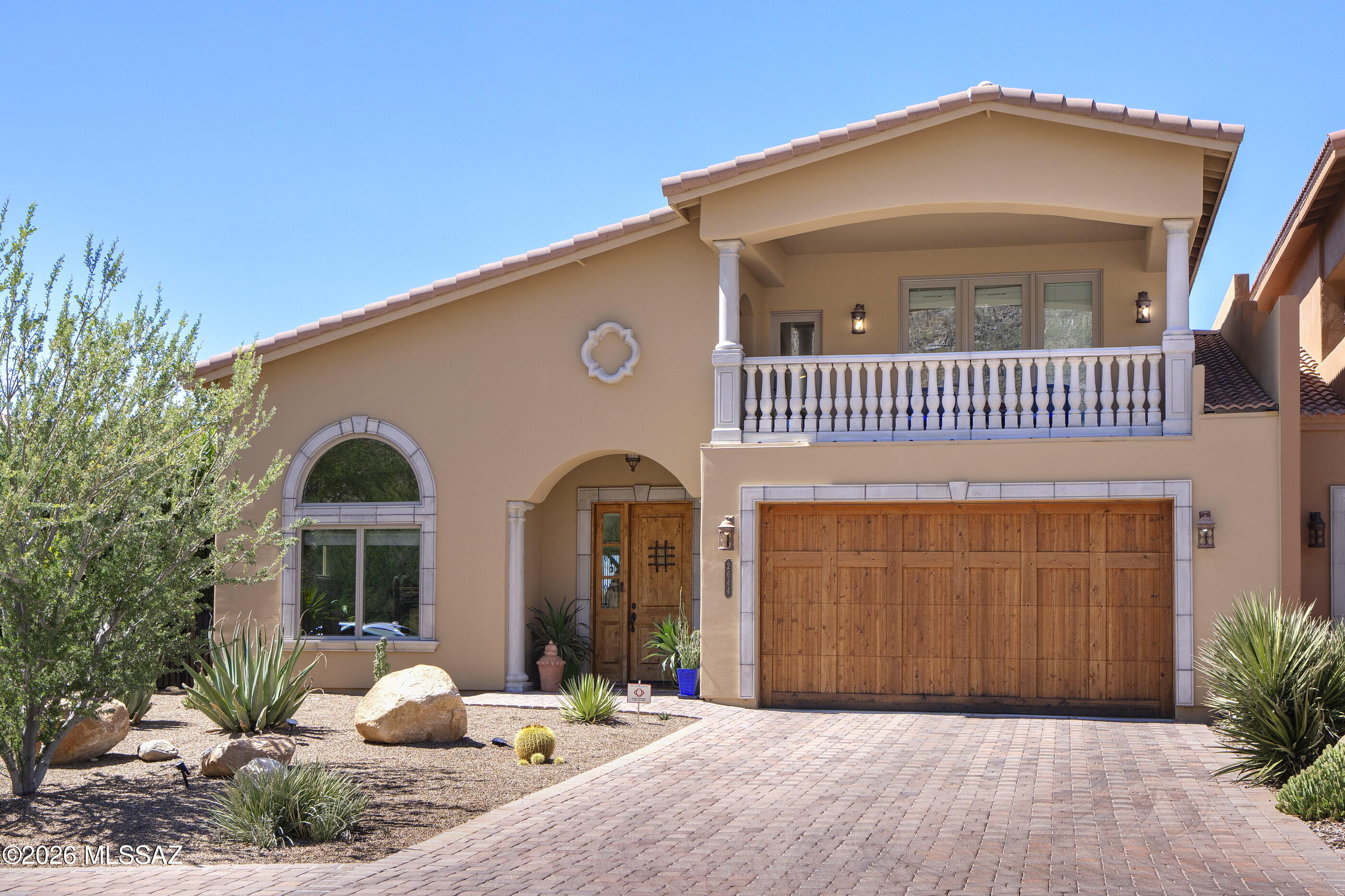 Located in the prestigious guard-gated community of Sin Vacas in the Catalina Foothills, this stunning custom-built townhouse sits on the largest lot in the subdivision & offers breathtaking mountain & city views. Built in 2016 & meticulously maintained, this thoughtfully designed home has 3 bedrooms plus an office & 2.5 baths. The spacious primary suite is conveniently located on the first floor. Each upstairs bedroom features its own private balcony, the perfect place to enjoy sunsets & surrounding mountain scenery. Recent upgrades include fresh interior & exterior paint, a new A/C unit, water filtration system & custom blinds. Step outside to a low-maintenance backyard w/ mature landscaping & enjoy access to a community pool. This is the perfect lock & leave home not to be missed!