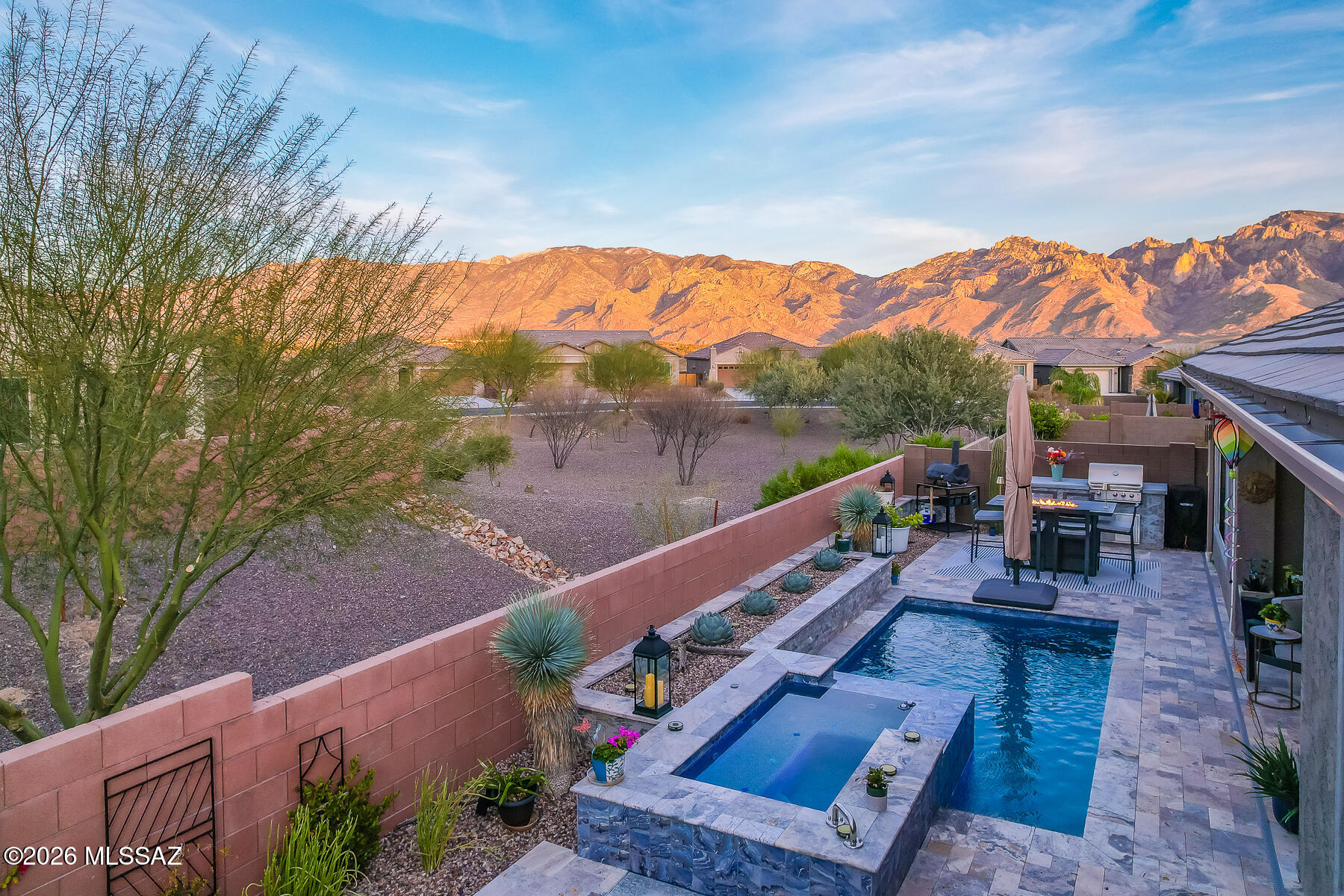 Incredible Catalina Mountain Views! Beautifully upgraded newer Pulte home on a private cul-de-sac lot in Rancho Vistoso with open space behind & stunning Catalina Mountain Views! Paver drive, walkways & courtyard welcome you into a light-filled interior with 10' ceilings & plank tile flooring. Gourmet kitchen features a large island, 5-burner gas cooktop, stainless steel appliances, walk-in pantry & tile backsplash. Dining Nook off kitchen with slider to covered patio. Open great room with walls of windows & linear gas fireplace. Split bedroom floor plan includes a luxurious owner's suite, flex room, and guest wing. Backyard oasis offers a PebbleTec pool/spa, travertine pavers, covered patio, artificial grass, built-in gas BBQ & separate 2-car + 1-car garages for extra storage space!