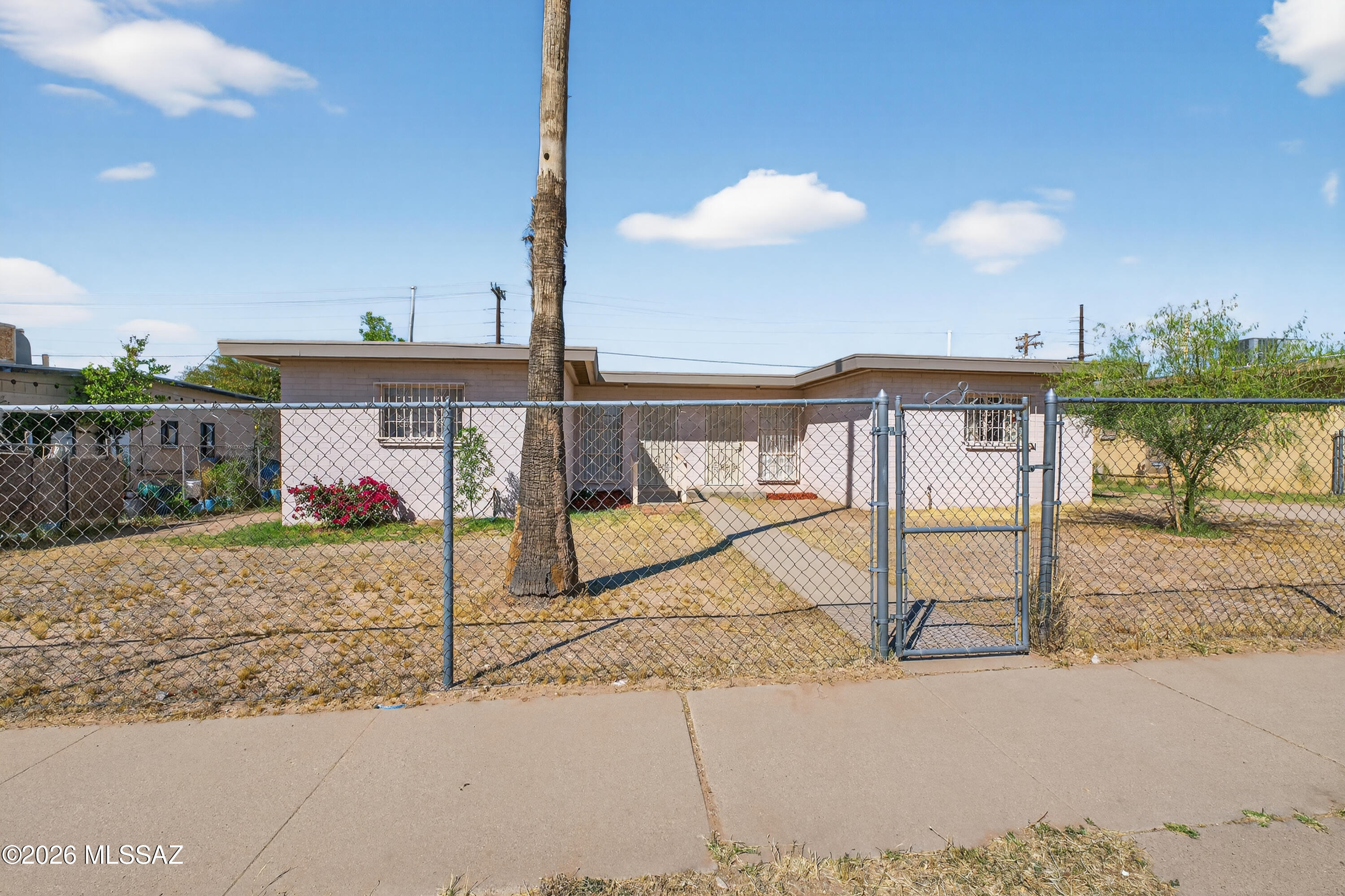 Spacious 1943 sq ft duplex. Each unit 971 sq ft. 2 bed 1 bath each unit has an extra room which could be a third bedroom. Ceramic tile through out both units. New roof, new HVAC, new electric panels 2026. Insides freshly painted. Fully fenced lot. Solid rental area. Backs to 36th St allowing alternative parking access. Due to 36th St access property ripe for possible rezoning to Multi-use. Buyer to verify. Easy Commute to downtown, Kino Sports Complex, Costco, Reid Park or UA.