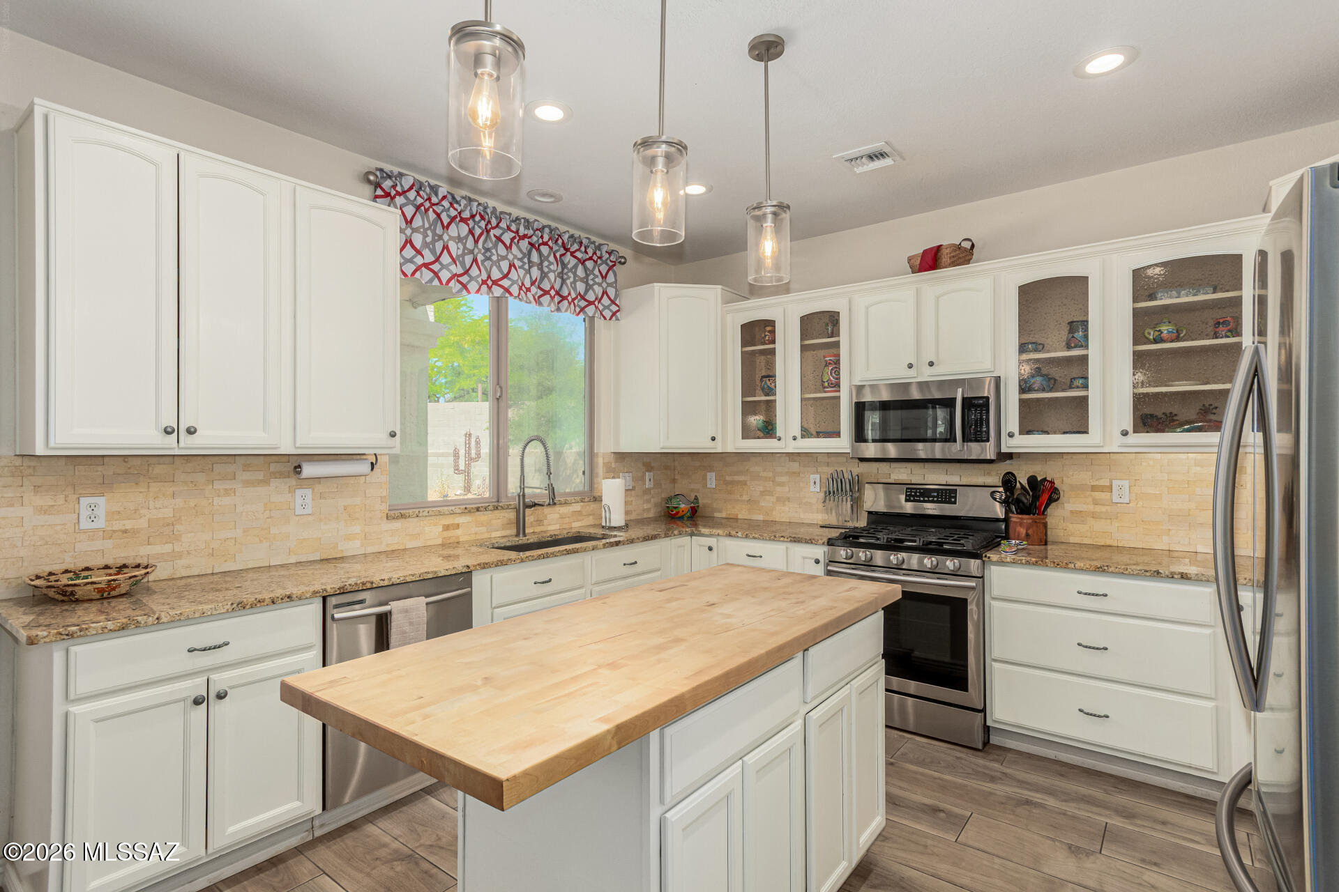 Come view this immaculate home, offering resort style living, boasting a bright, open floor plan, high ceilings, plank tile floors, and updated kitchen. Kitchen features SS appliances, gas range, granite counters, cut stone backsplash, lots of cabinets and an island. Main level has a bonus room (could be used as a bedroom with bunk beds), a full bath, formal living, formal dining, family room and eat in kitchen. Walk out to the gorgeous backyard w/ lrg covered patio, pebble tech pool w/ waterfall feature, mature, low care landscaping. Upstairs features the primary bedroom w/ soaking tub/ shower and walk-in closet. Two secondary bedrooms share a hall bath. Was a short-term rental property, managed by Vacasa, potential income! Three car garage. All on a lrg.27 acre cul-de-sac lot.