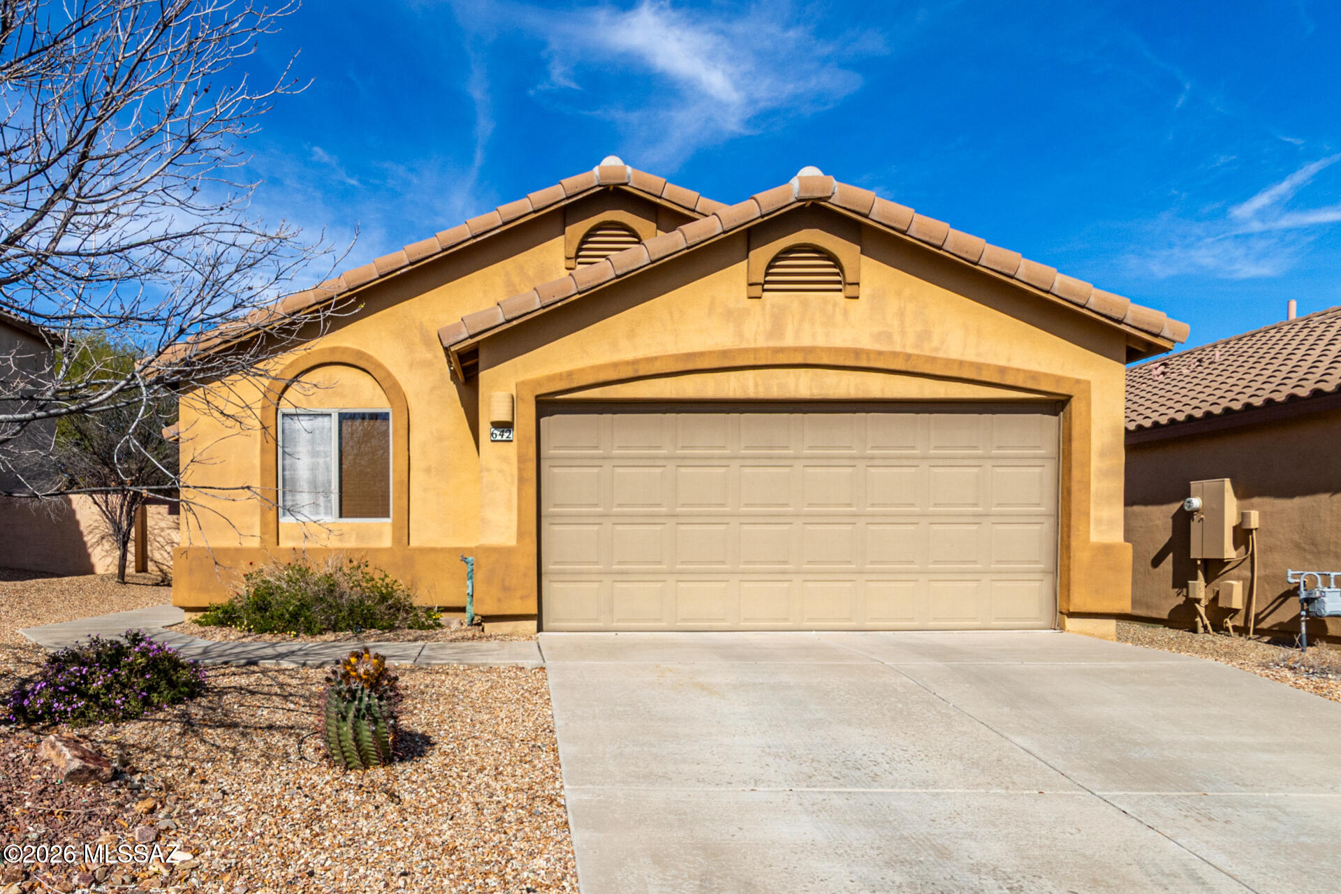 This lovely single-story home awaits you in The Presidios at Rancho Sahuarita! Designed with comfort in mind, featuring 3 bedrooms + den, 2 bathrooms & a 2-car garage. Inside, you'll find sizable living spaces with vaulted ceilings, tile flooring, carpet in all the right places, arched passageways & a neutral palette. Whip up your signature dishes in the well-appointed kitchen, showcasing ample cabinetry and counter space, SS appliances, and an island, perfect for quick meals. Enjoy a good night's rest in the main suite, showcasing a walk-in closet and a full ensuite with a separate shower & tub. The den is perfect for a home office or quiet retreat. Out back, you'll have a cozy covered patio perfect for relaxation, well-laid pavers, and a serene landscape. Hurry up, this gem won't last!